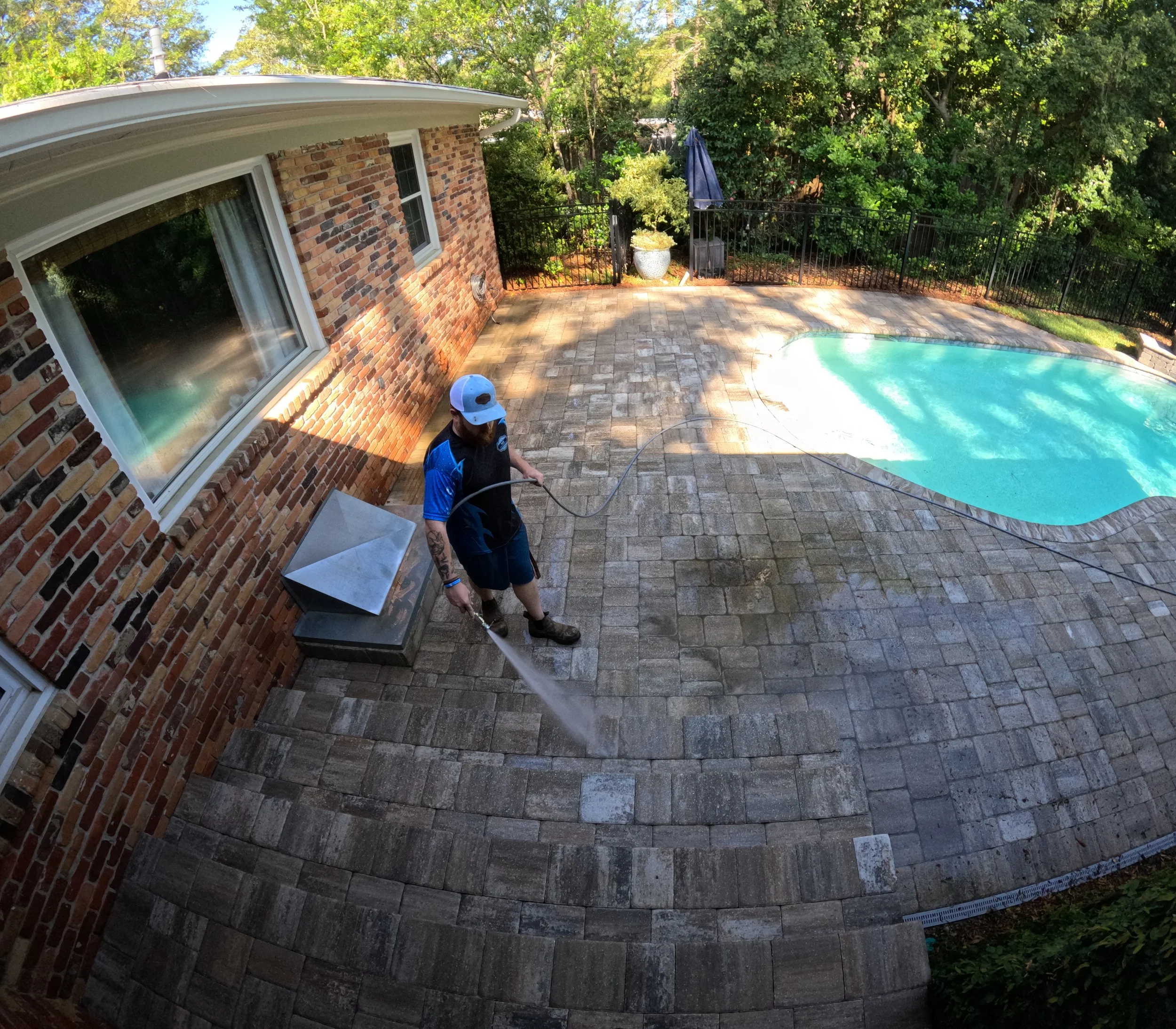 Owner Bryan Decambra doing a final rinse down of the recently cleaned paver deck and preparing for stage 2 of their paver sealing project!