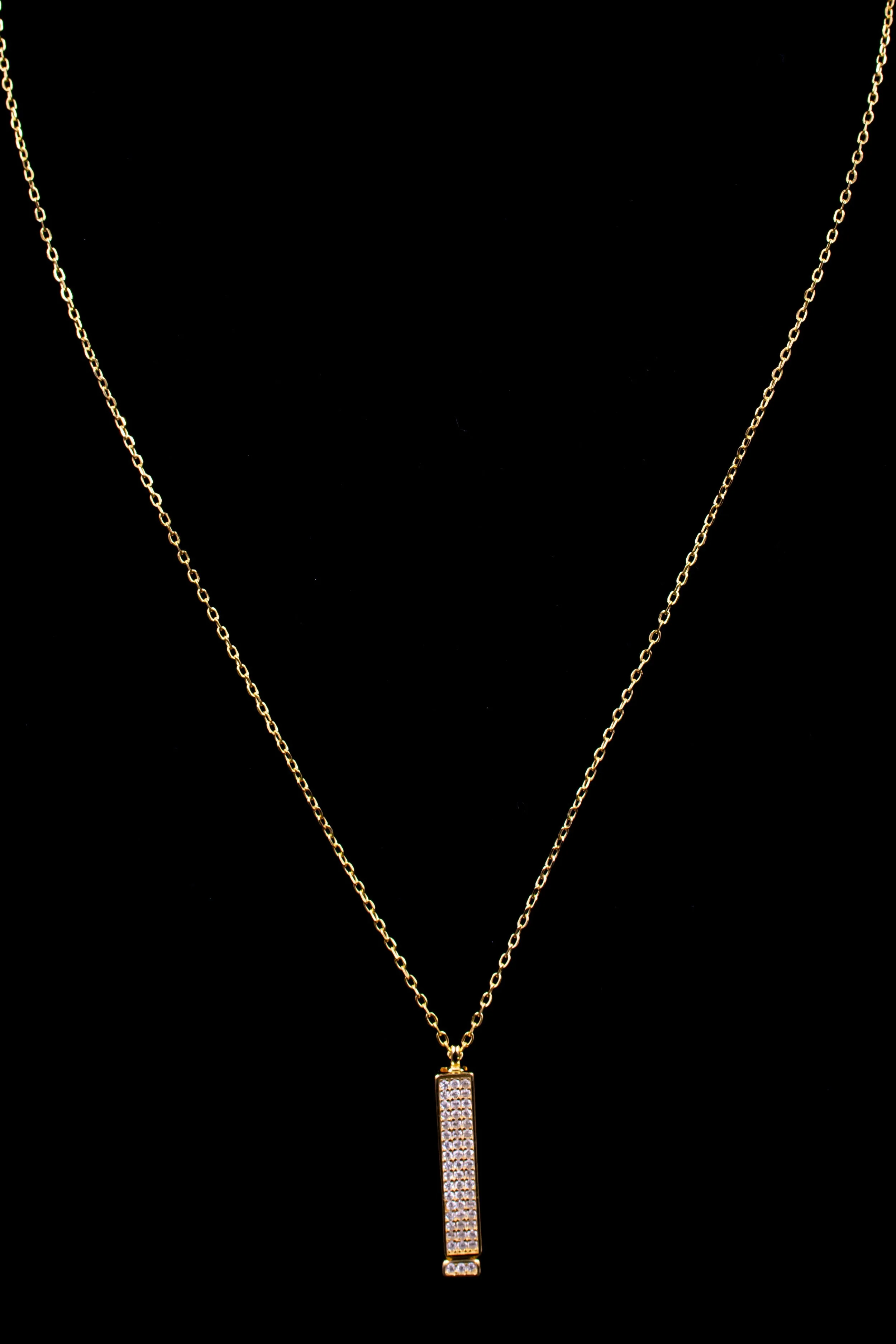 Gold chain necklace with a rectangular pendant encrusted with small diamonds