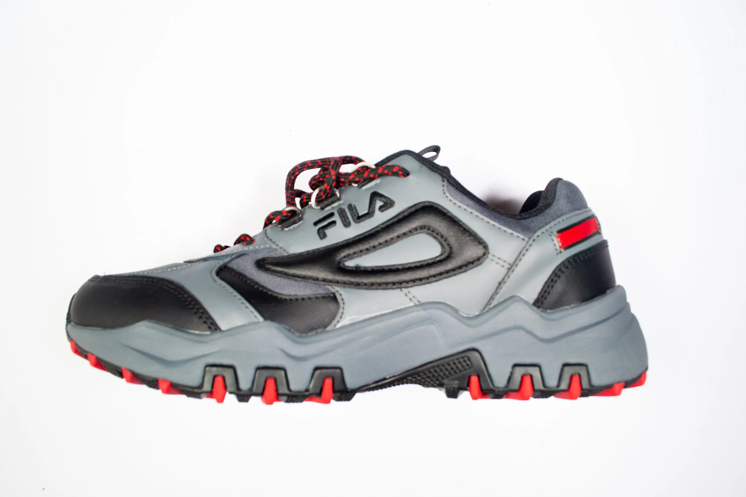 Gray and black FILA athletic sneaker with red accents and a chunky sole.