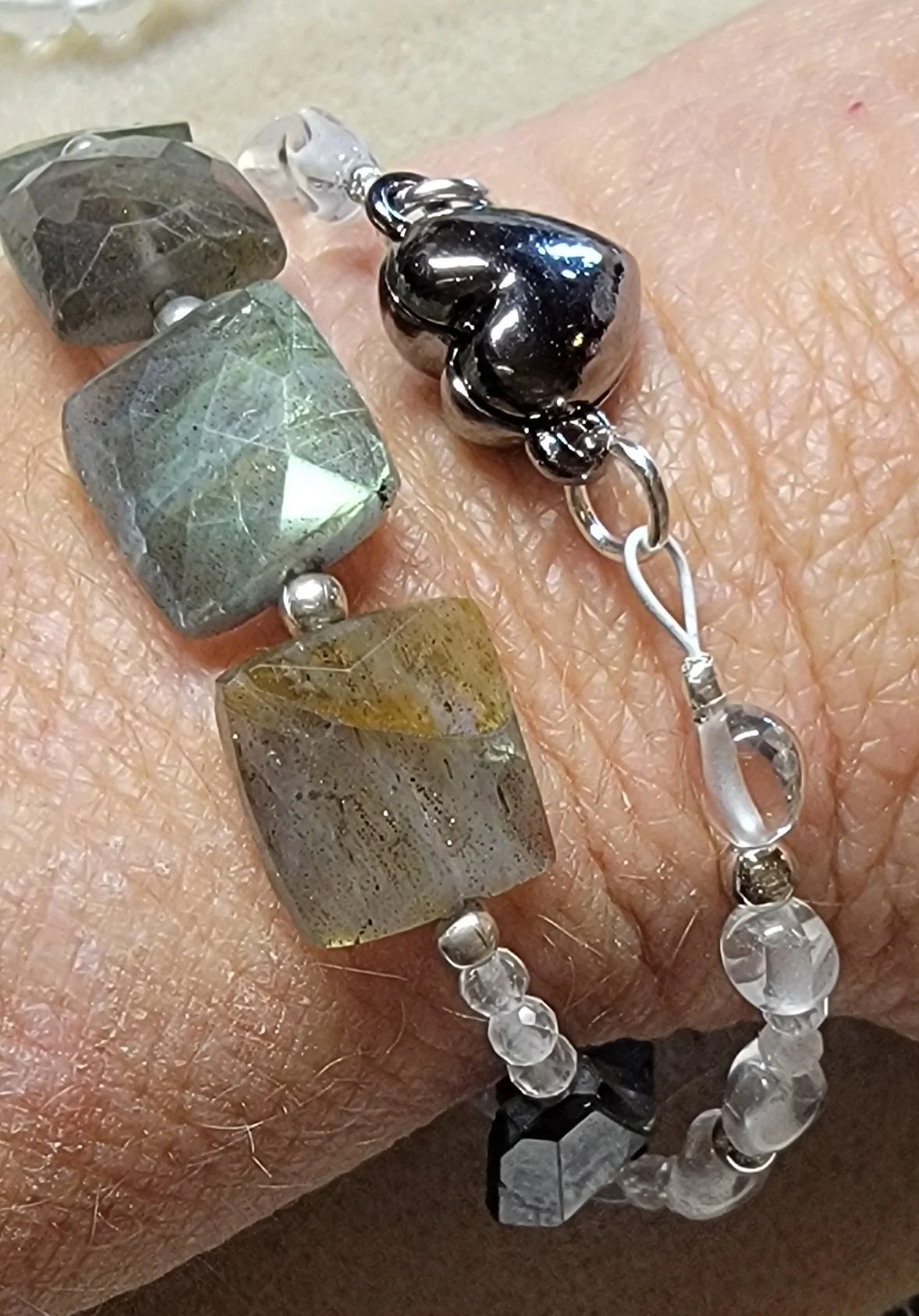 Handcrafted bracelets made with eco‑conscious gems, and labradorite rectangles