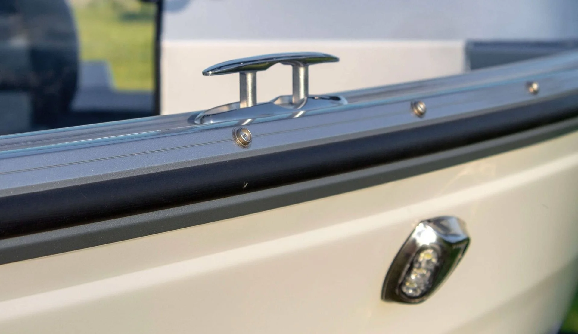 Close-up of a boat's bow with metal hardware and a small light.