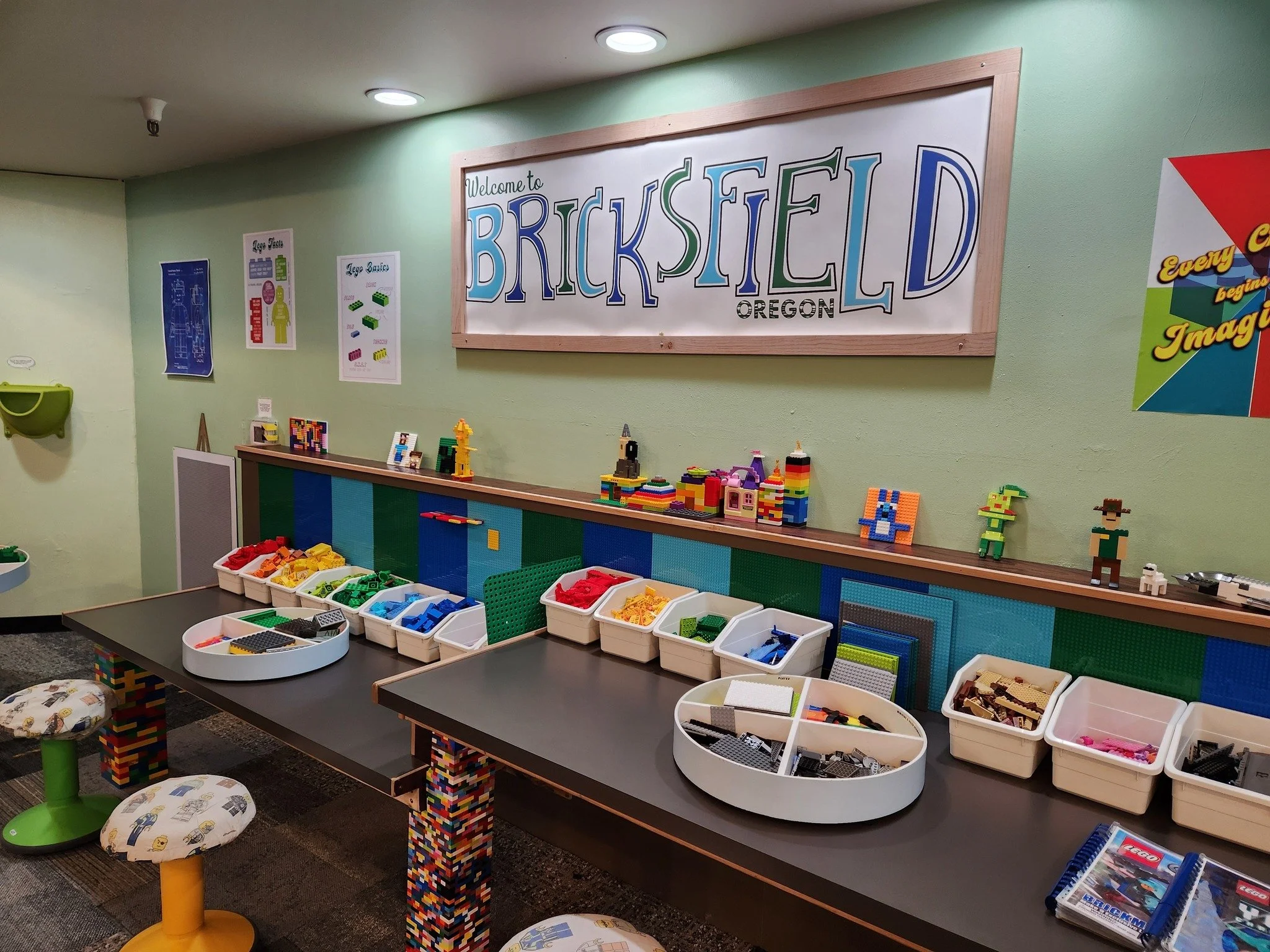 station at museum called Bricksfield with colored bricks organized in white containers on a counter with