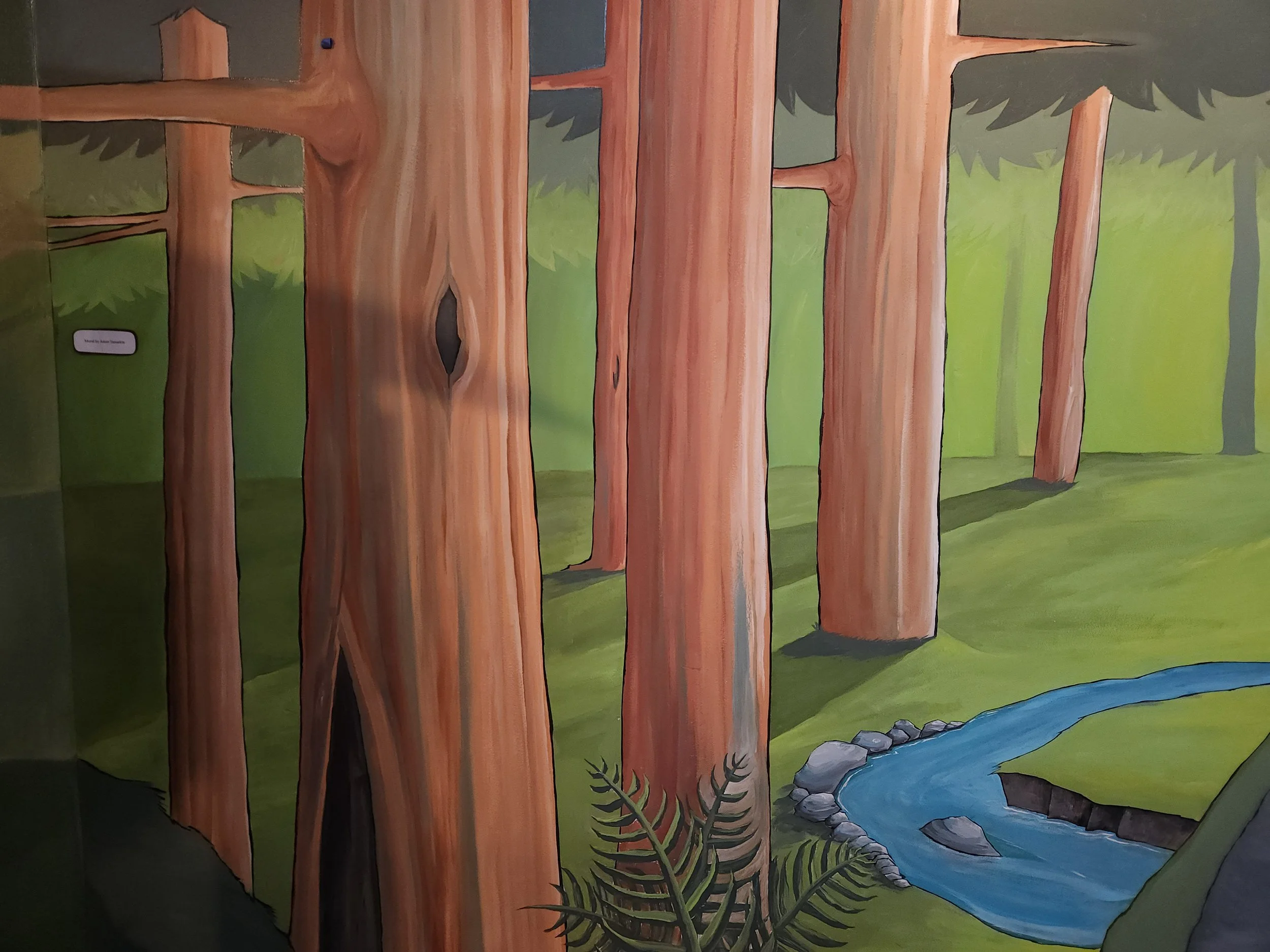 A close-up of the mural expanding the exhibit wall, created by artist Adam Tamarkin.