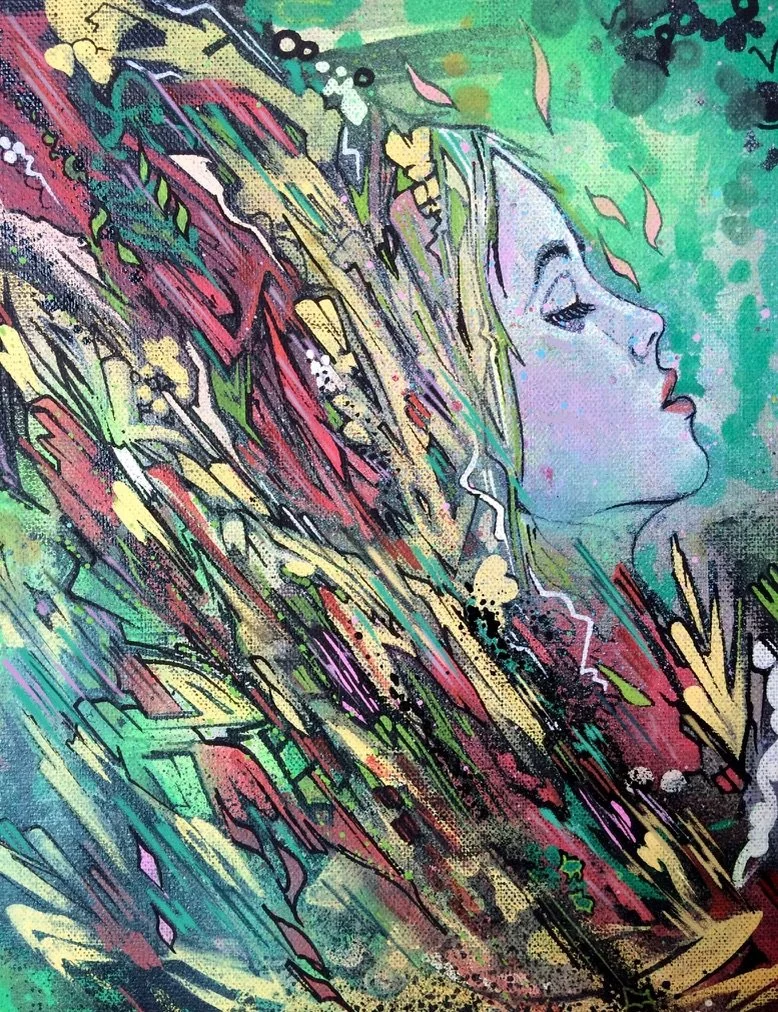 A colorful abstract mural featuring a side profile of a woman's face with closed eyes, surrounded by vibrant streaks of paint, leaves, and various artistic patterns.