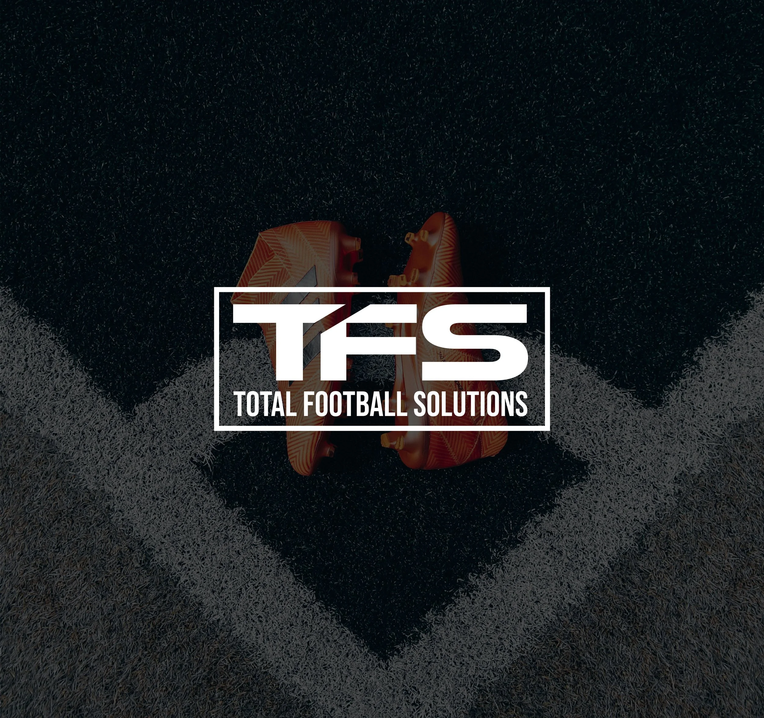 Soccer field corner with orange soccer cleats and Total Football Solutions logo in the center.
