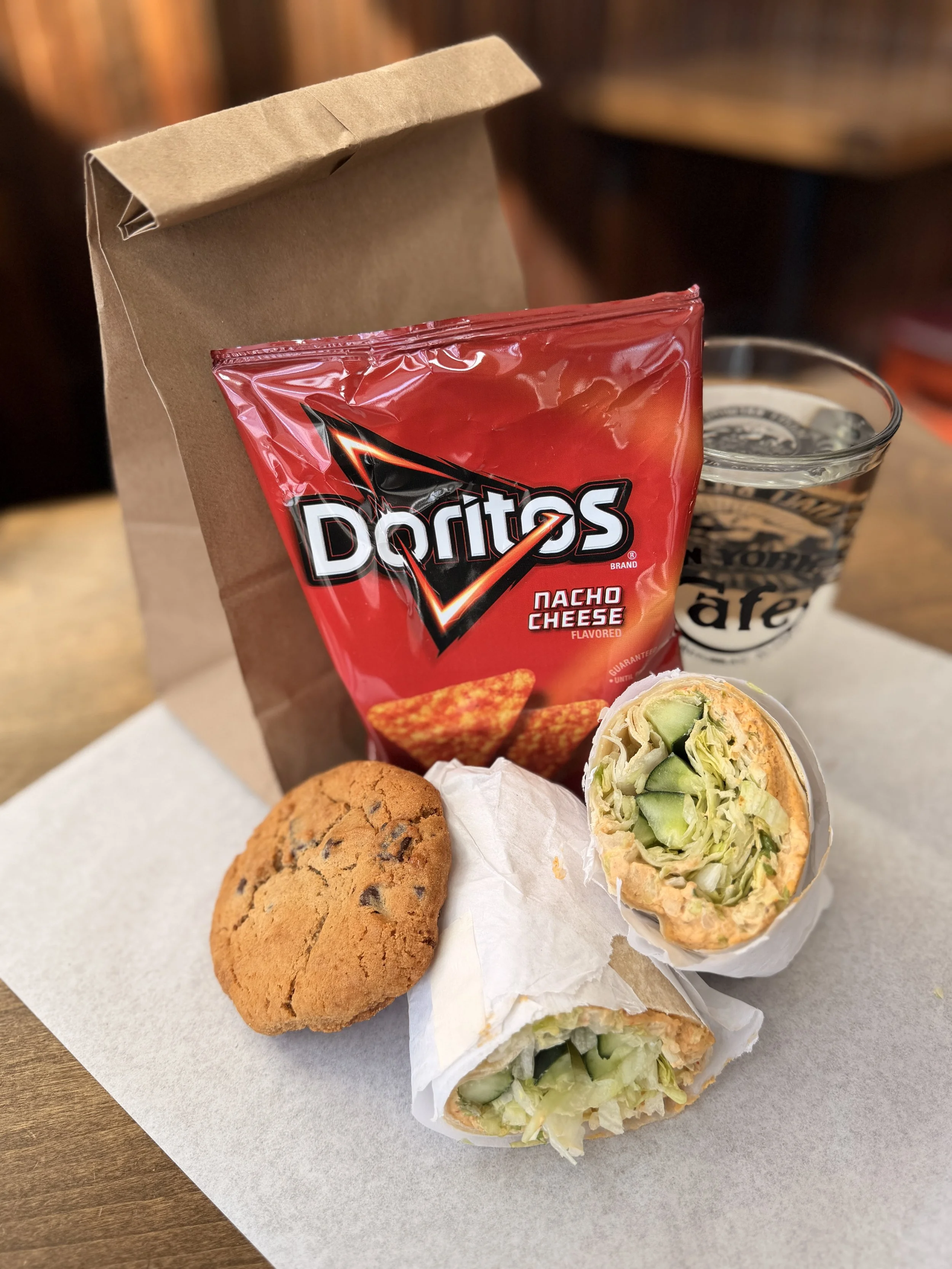 Vegan wrap, hummus, cookie, chips, drinks, whales and lunch