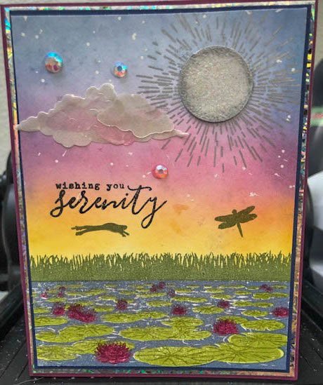 A magical card with frogs dragonflies moon and cloud