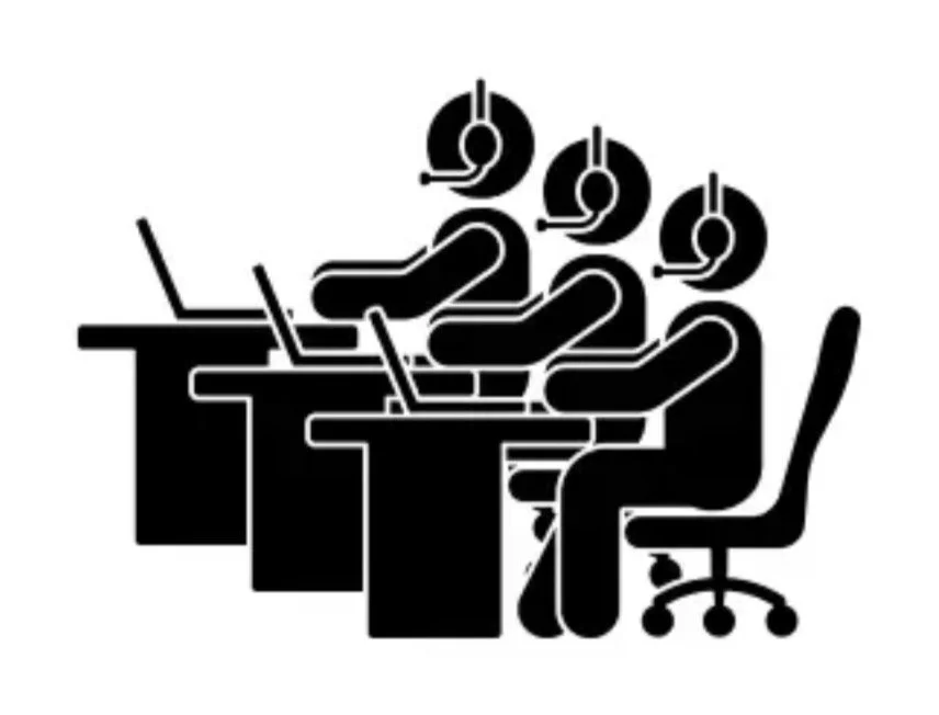 Three people working at desks with computers and headsets in an office setting