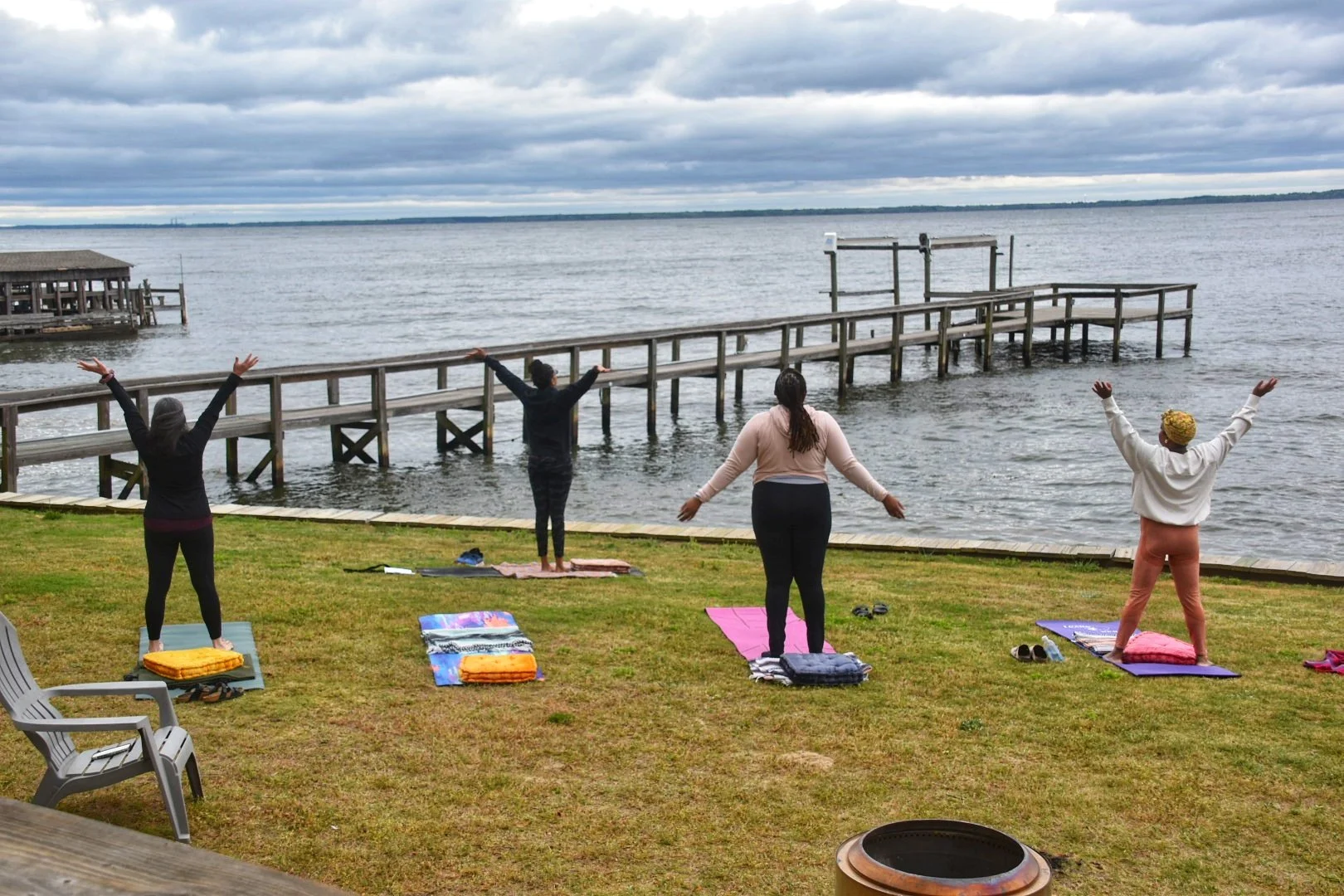 Group by the lake in yoga pose