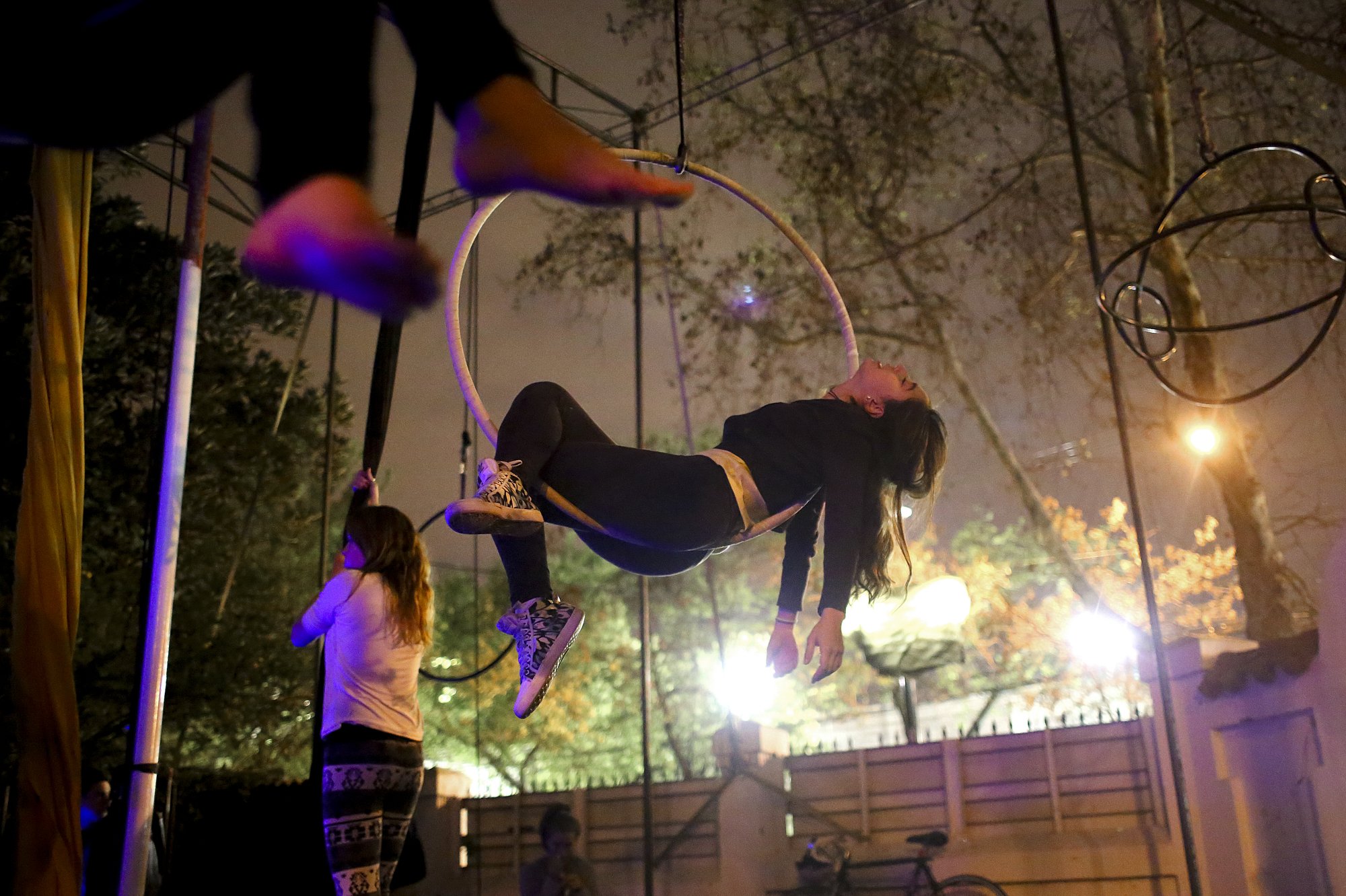 A girl rests in a lyra during an aerial acrobatics class at 7Siete, an aerial arts school, in Santiago, Chile. 