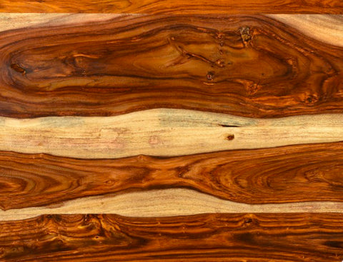 Close-up of a wooden surface with natural grain and color variations.