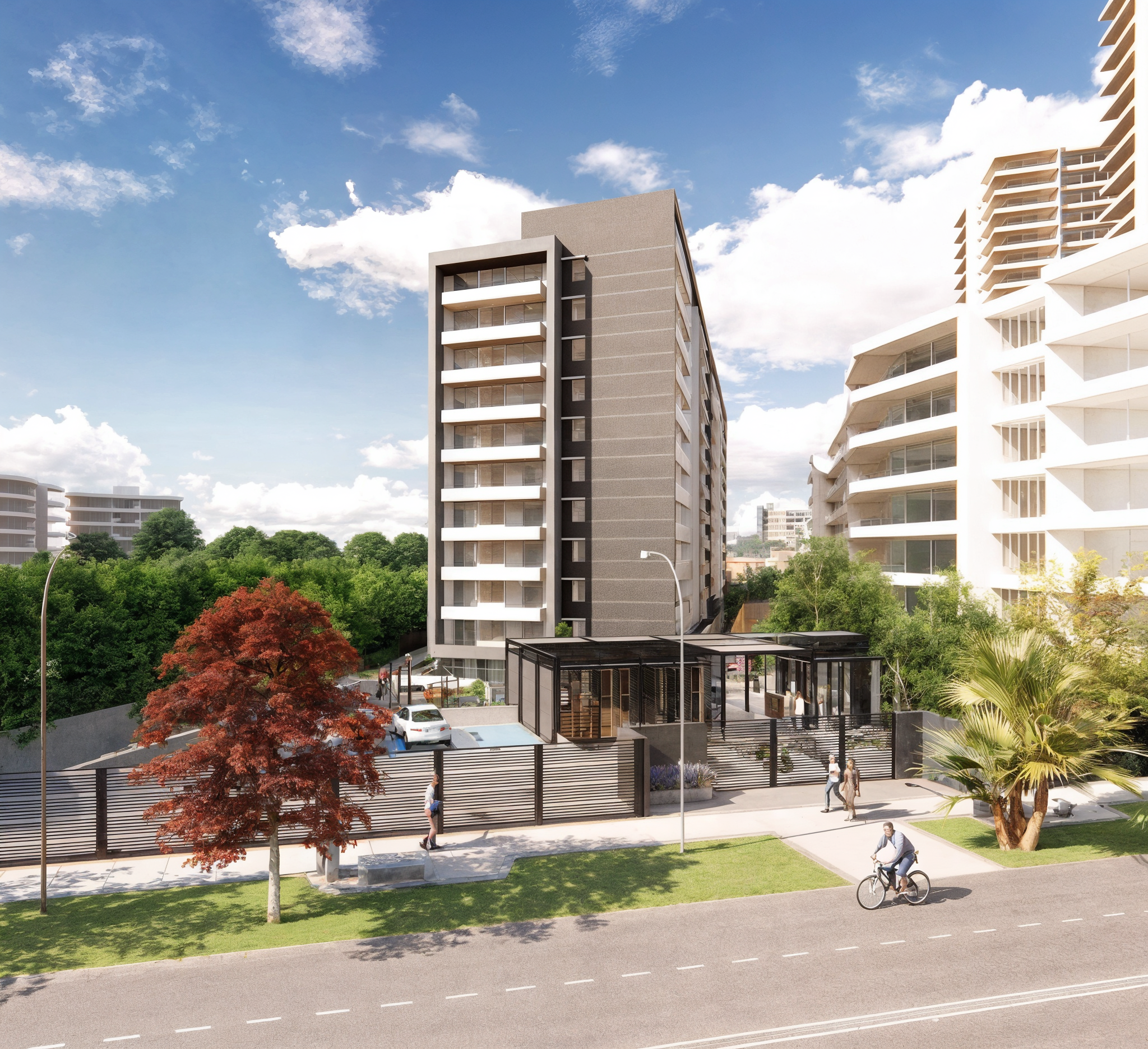 Modern multi-story residential buildings with balconies, surrounded by trees and greenery, with a man riding a bicycle on the street in front.