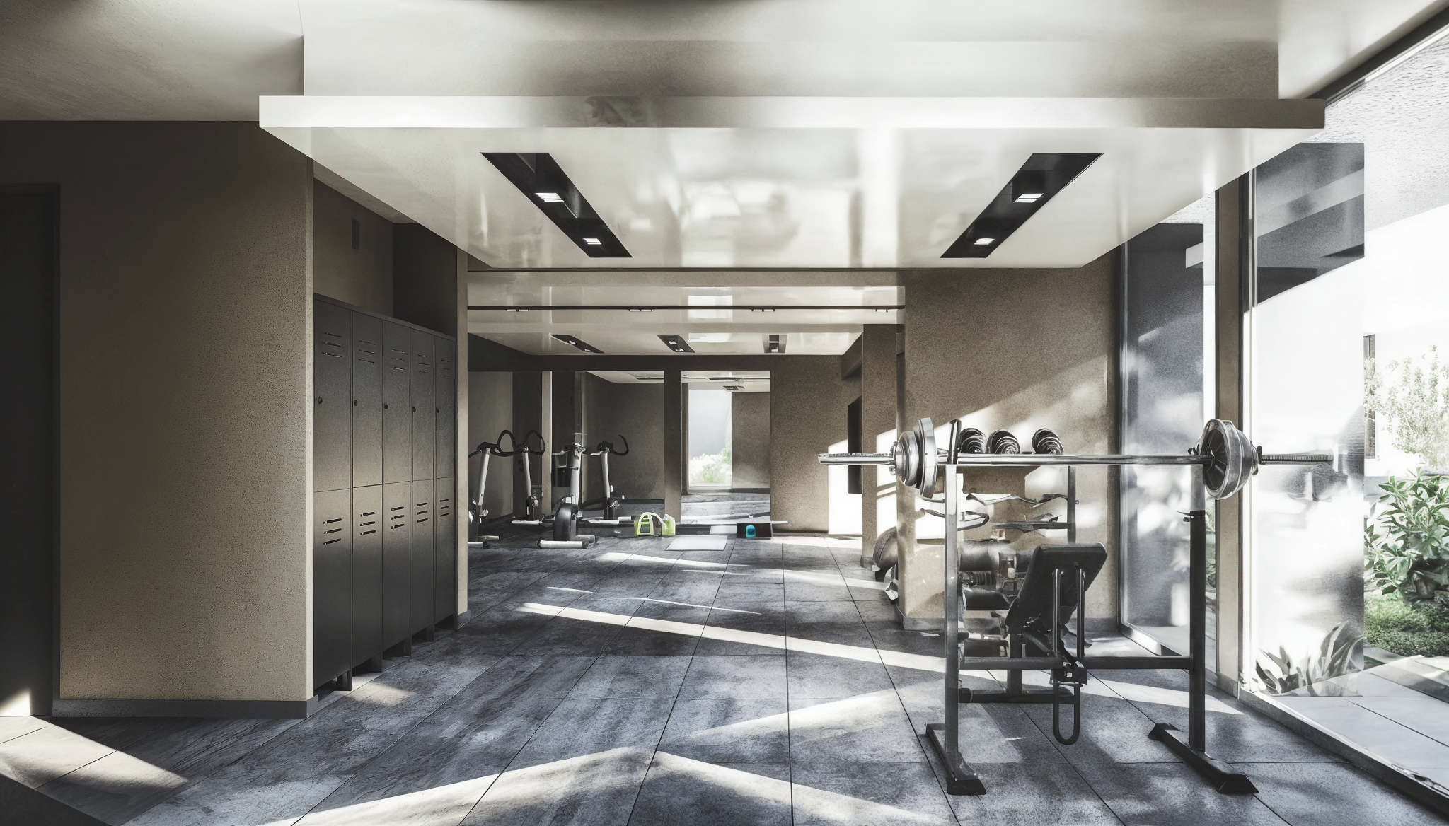 Empty modern gym with lockers, exercise bikes, and a weightlifting station near large windows letting in sunlight.