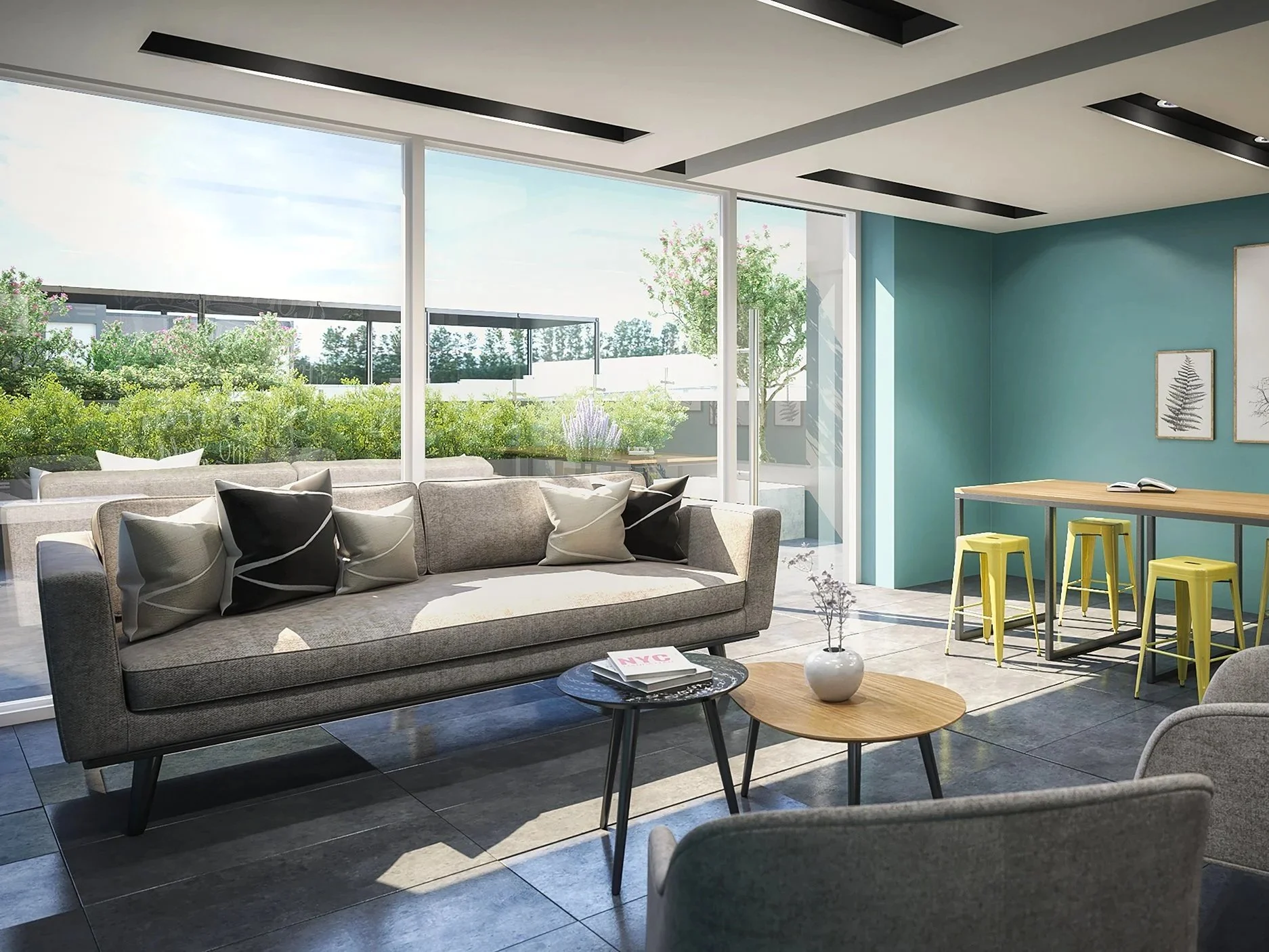 Modern living room with large windows, beige sofa with black and white pillows, small round coffee tables with magazines and a vase, a high table with yellow stools, framed artwork on teal wall, green outdoor garden visible through windows.