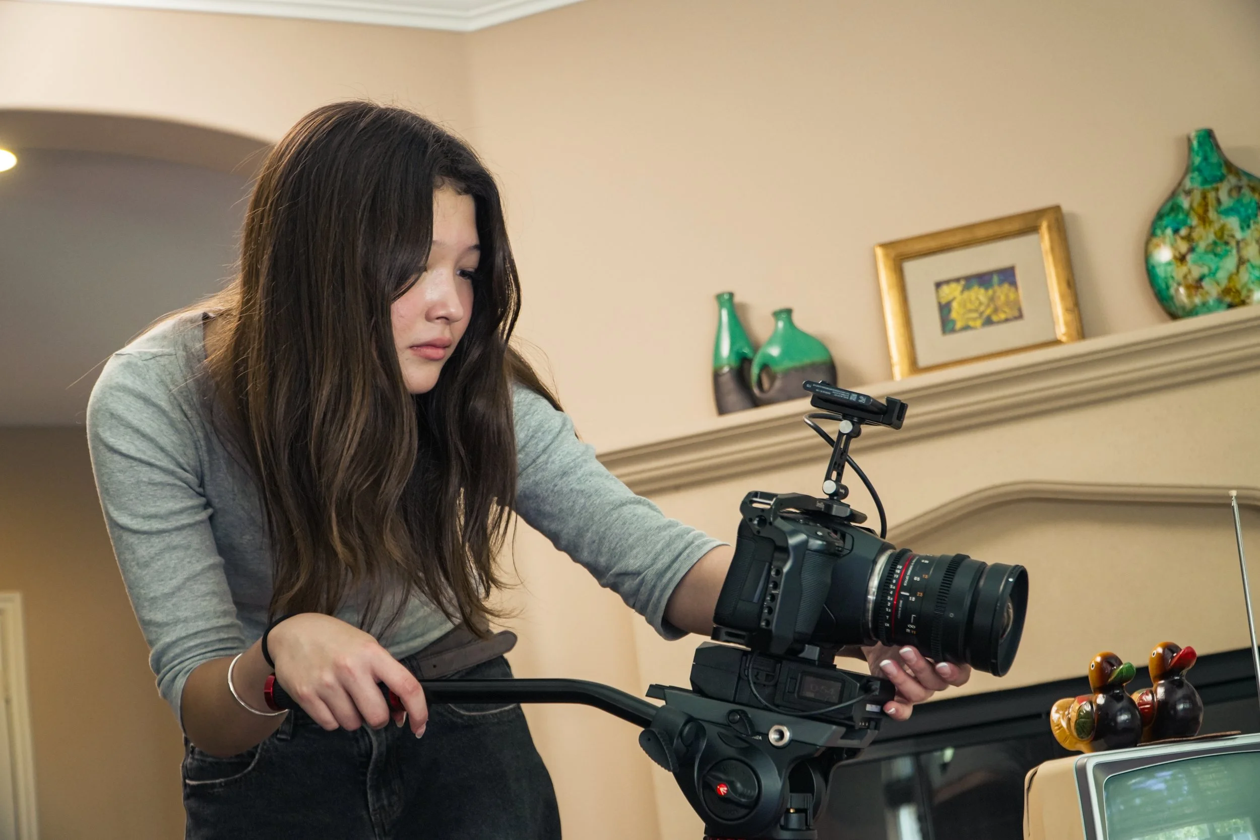 Woman operating a professional video camera indoors