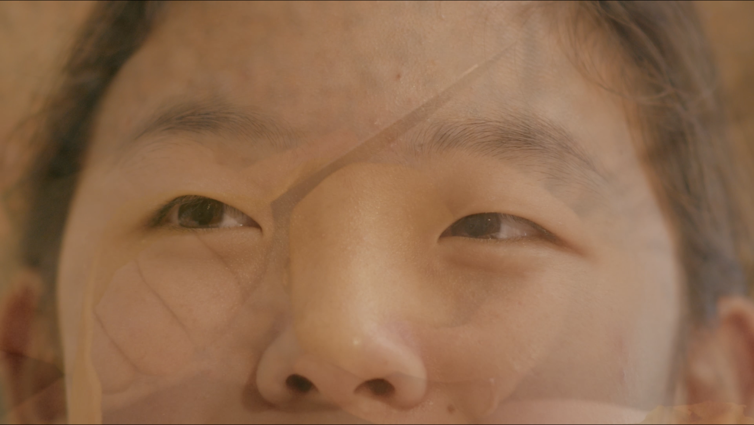 Extreme close-up of a person’s eyes, eyebrows, nose, and upper cheeks