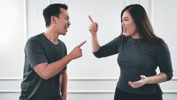 A couple arguing after co-signing a loan, illustrating how financial stress can damage personal relationships.
