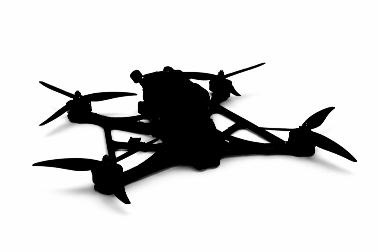 Silhouette of a drone with four propellers on a white background.