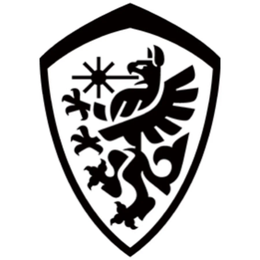 Black and white shield emblem featuring a stylized eagle with outstretched wings, a star above its head, and various other decorative elements.