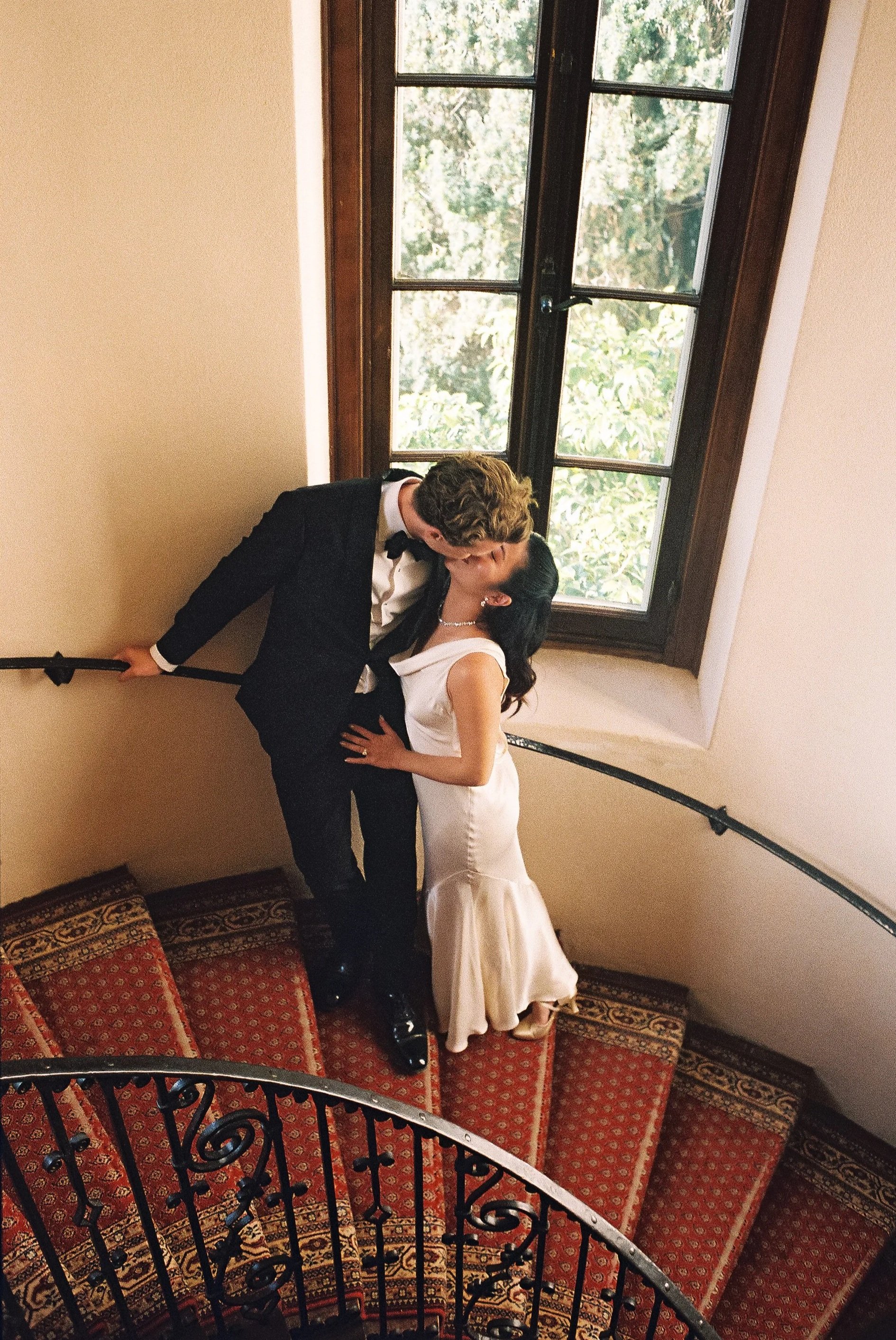 bride and groom kissing, stairwell, Stonepine estate wedding