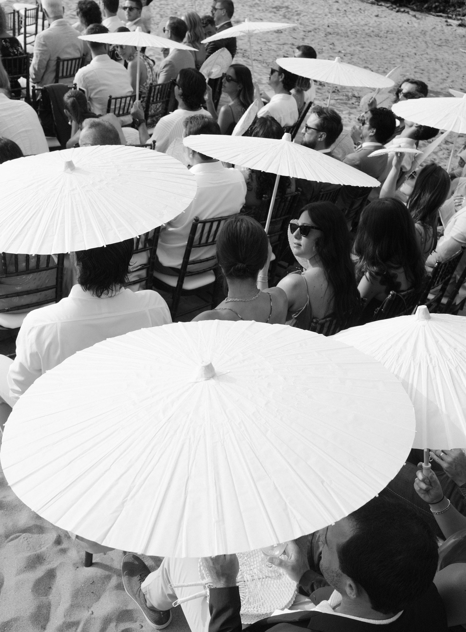 a drone shot of parasols at the wedding ceremony