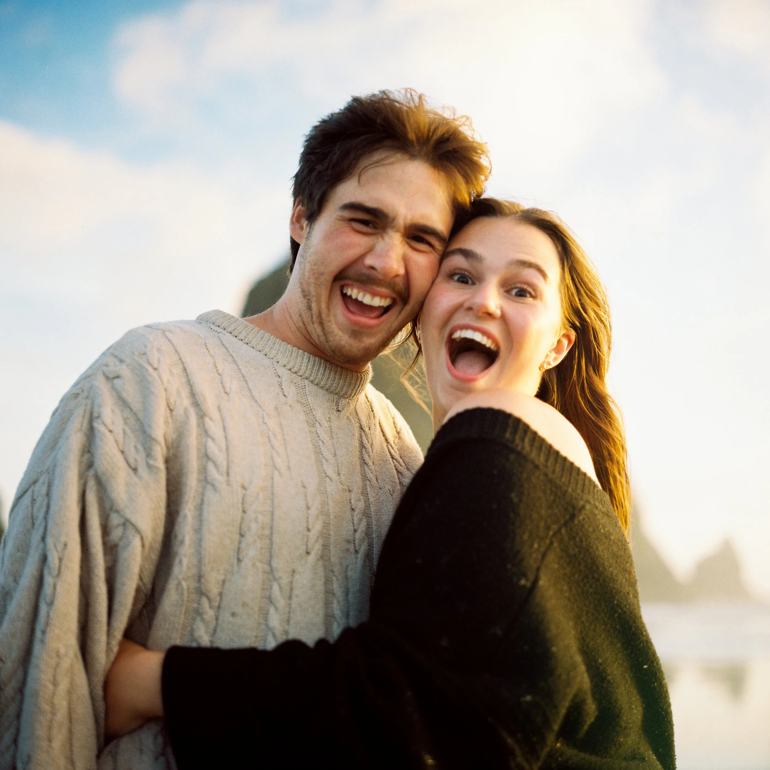 a engagement couple looking at the camera with a funny face on 120mm film