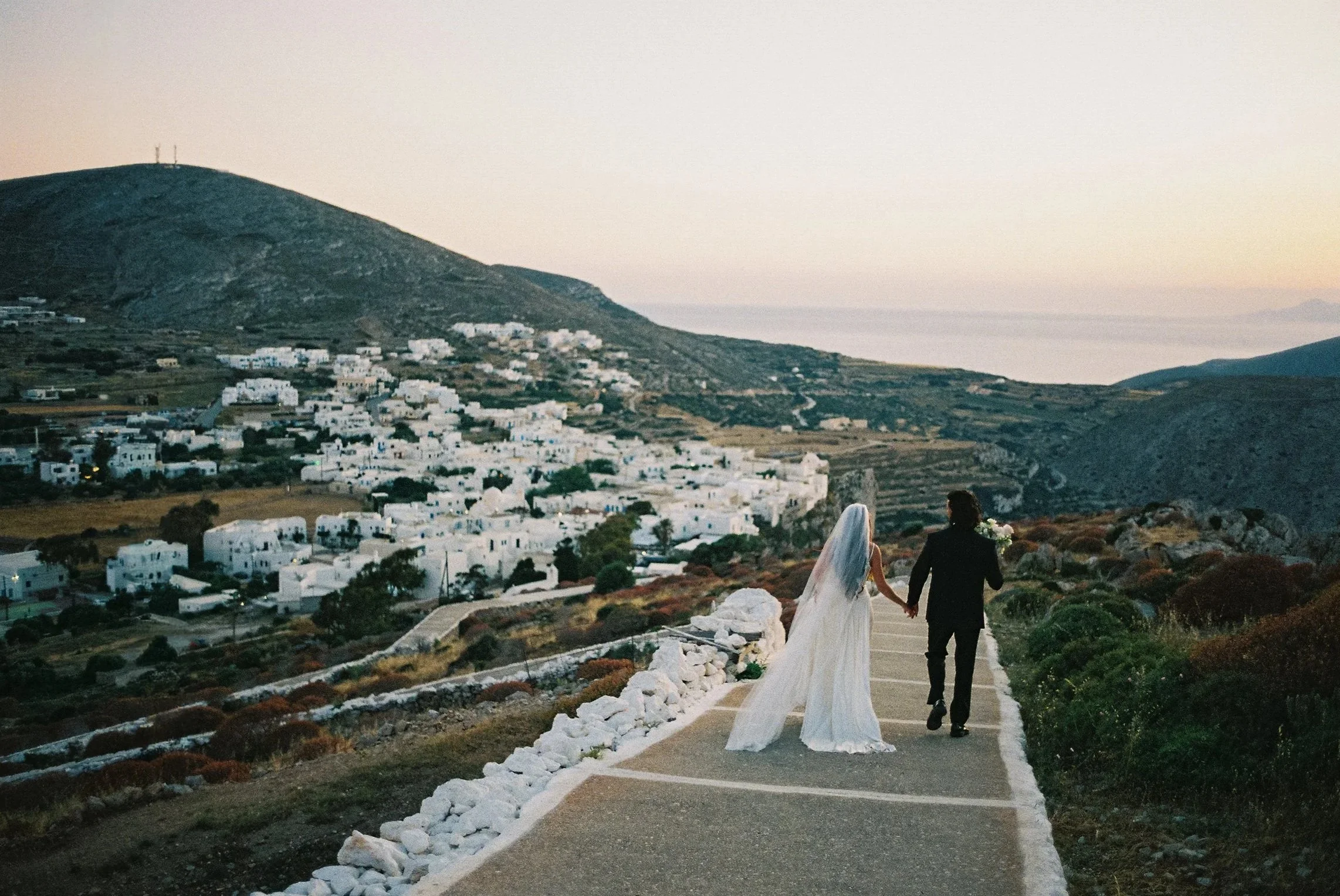 Bride and Groom walking at their wedding, folegandros greece