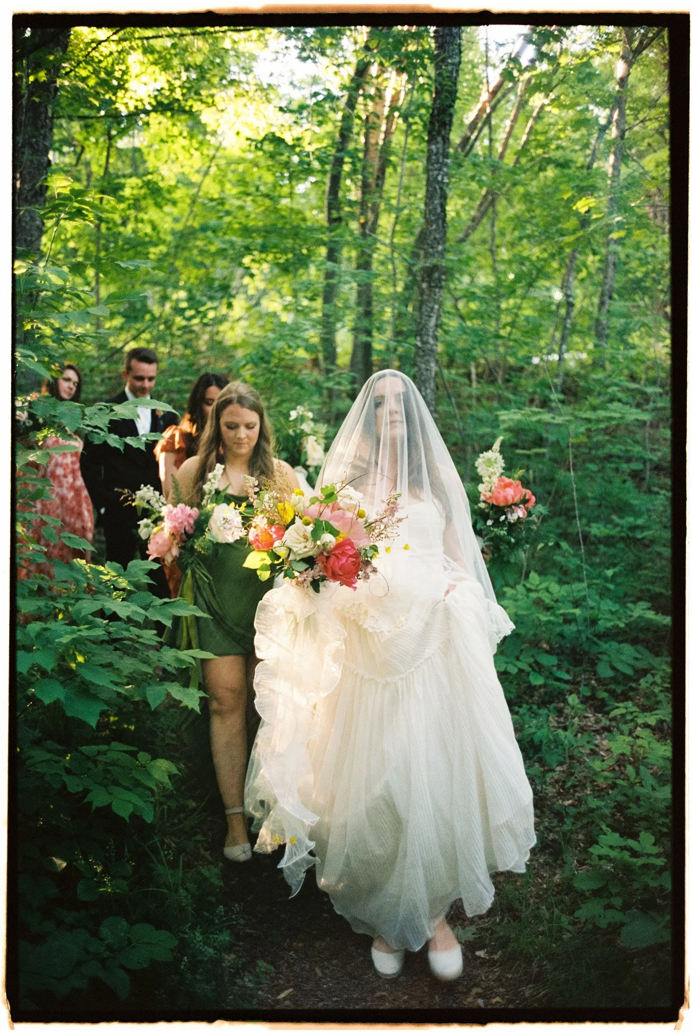 the bride walking down the aisle with her wildflower bouquet