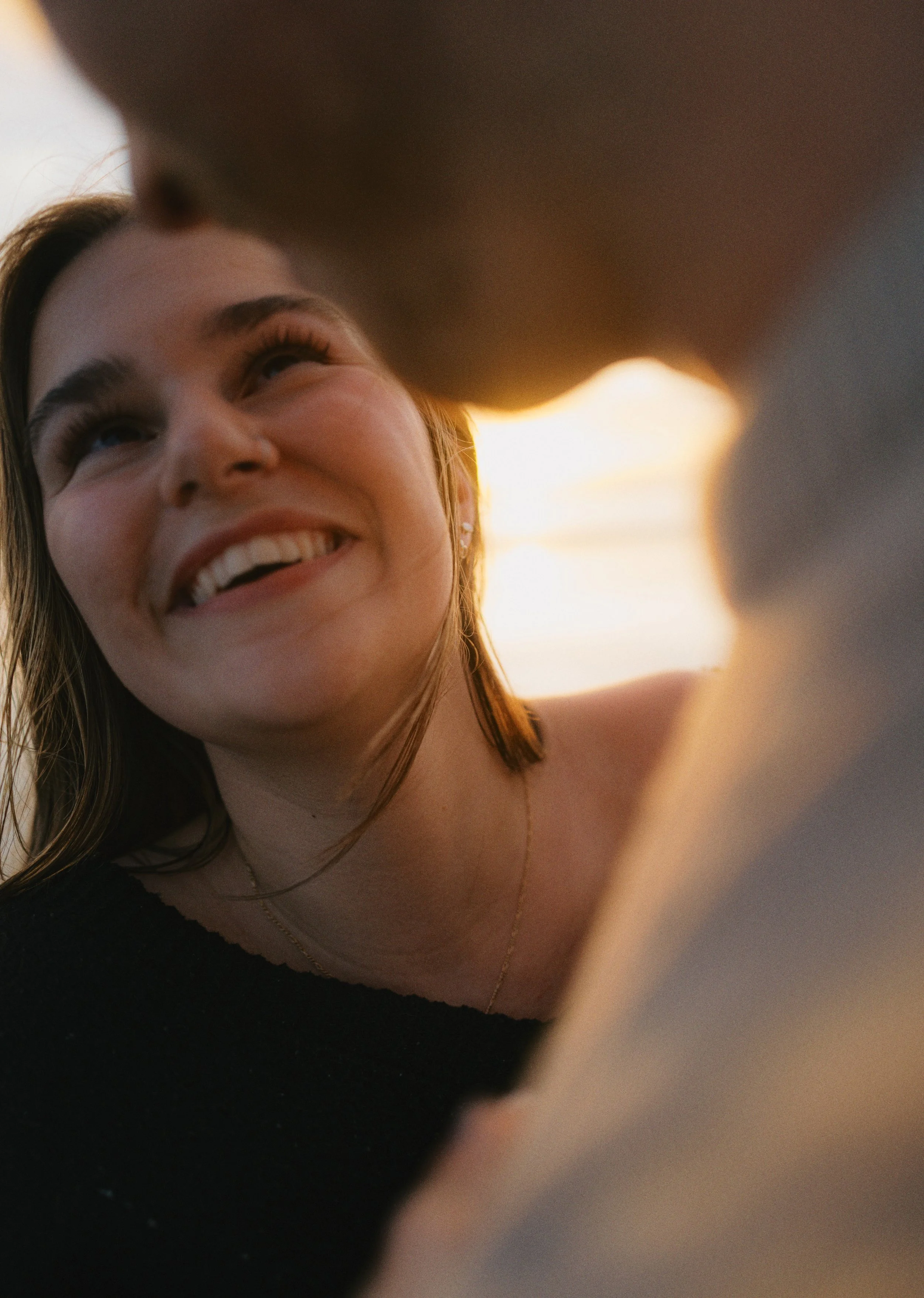 a bride starting lovingly at her groom at sunset candid film photo