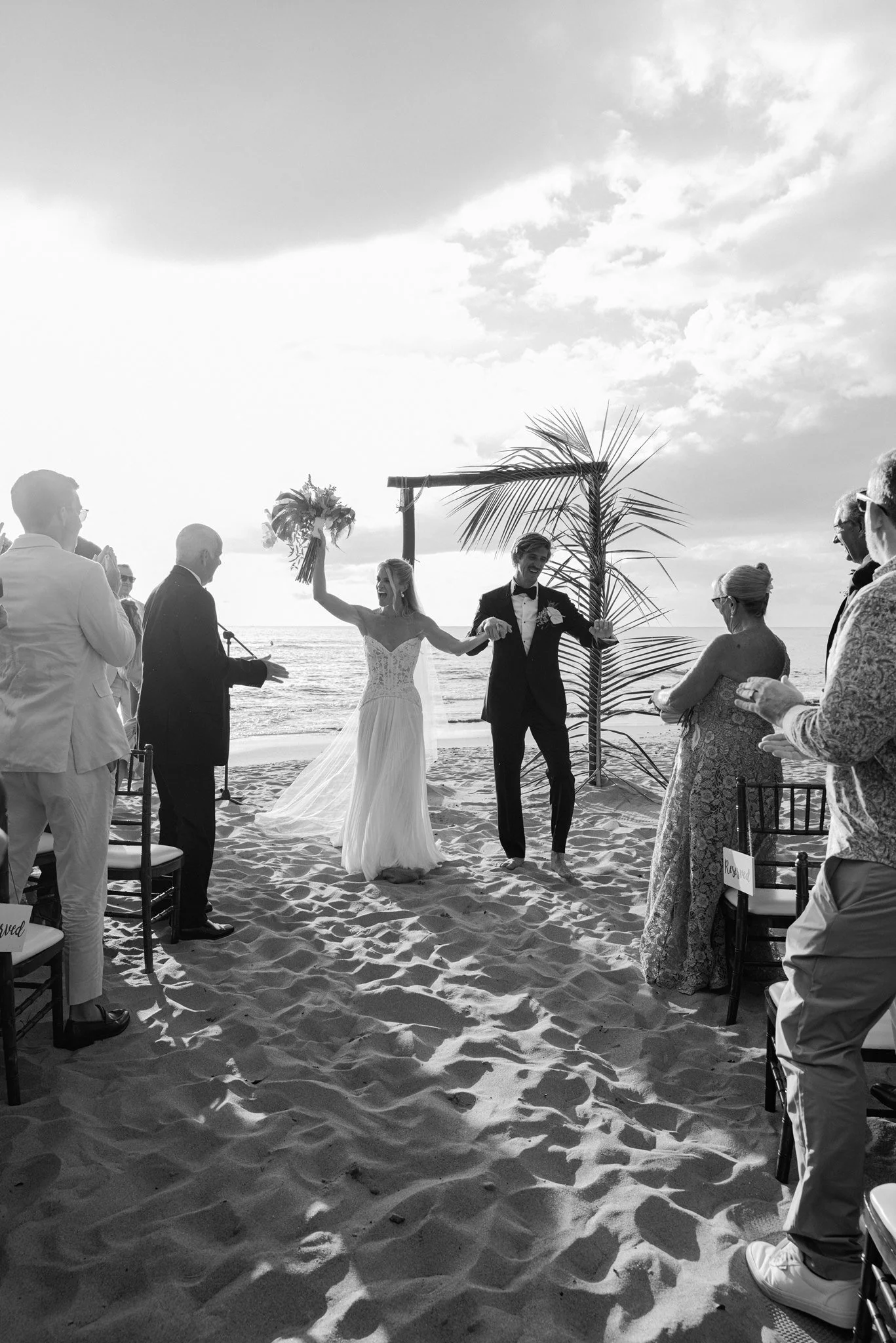 the bride and groom celebrating at the wedding ceremony in puerto rico