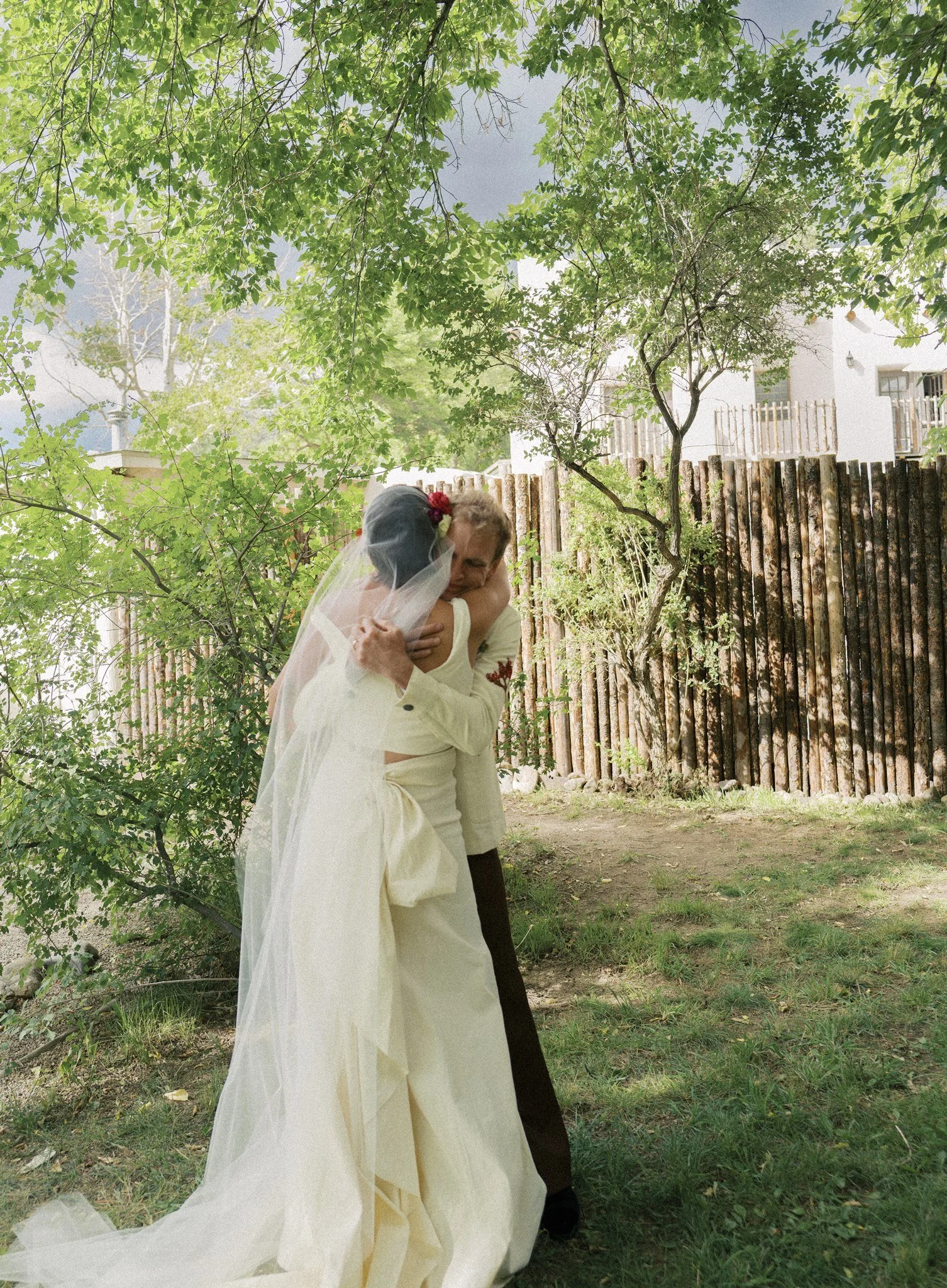 a groom hugging his bride after the ceremony in taos new mexico