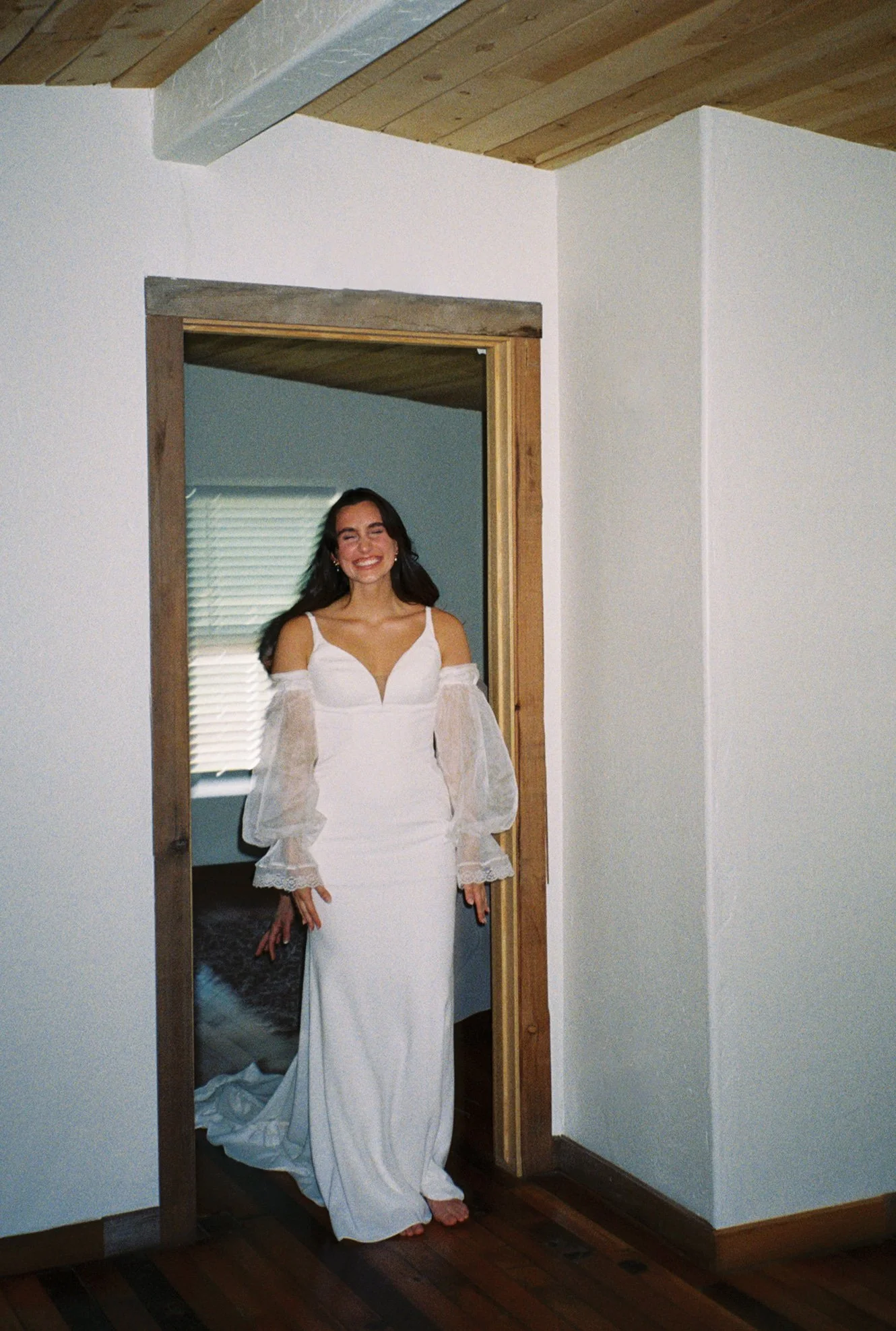the bride laughing and smiling as she shows her first look to her bridesmaids in arizona