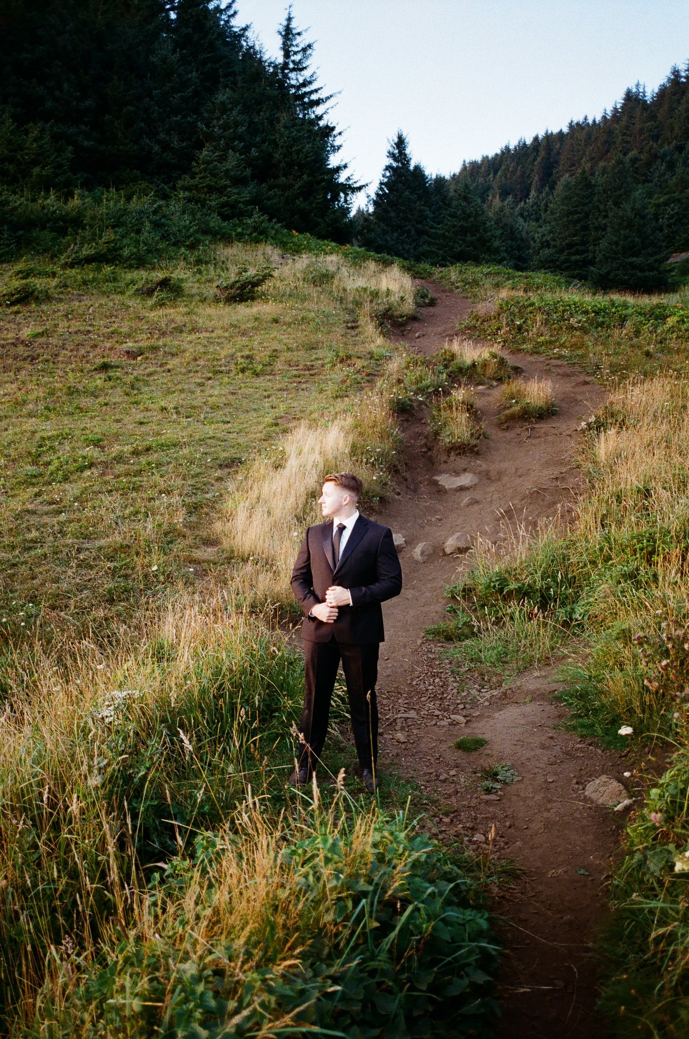 a groom nervously standing on the cliffs on the oregon coast