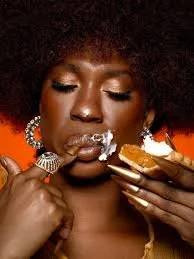 Image of black woman model eating a slice of sweet potato pie and whipped cream 