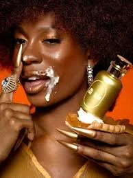 Image of black woman model holding a slice of sweet potato pie and whipped cream on her face