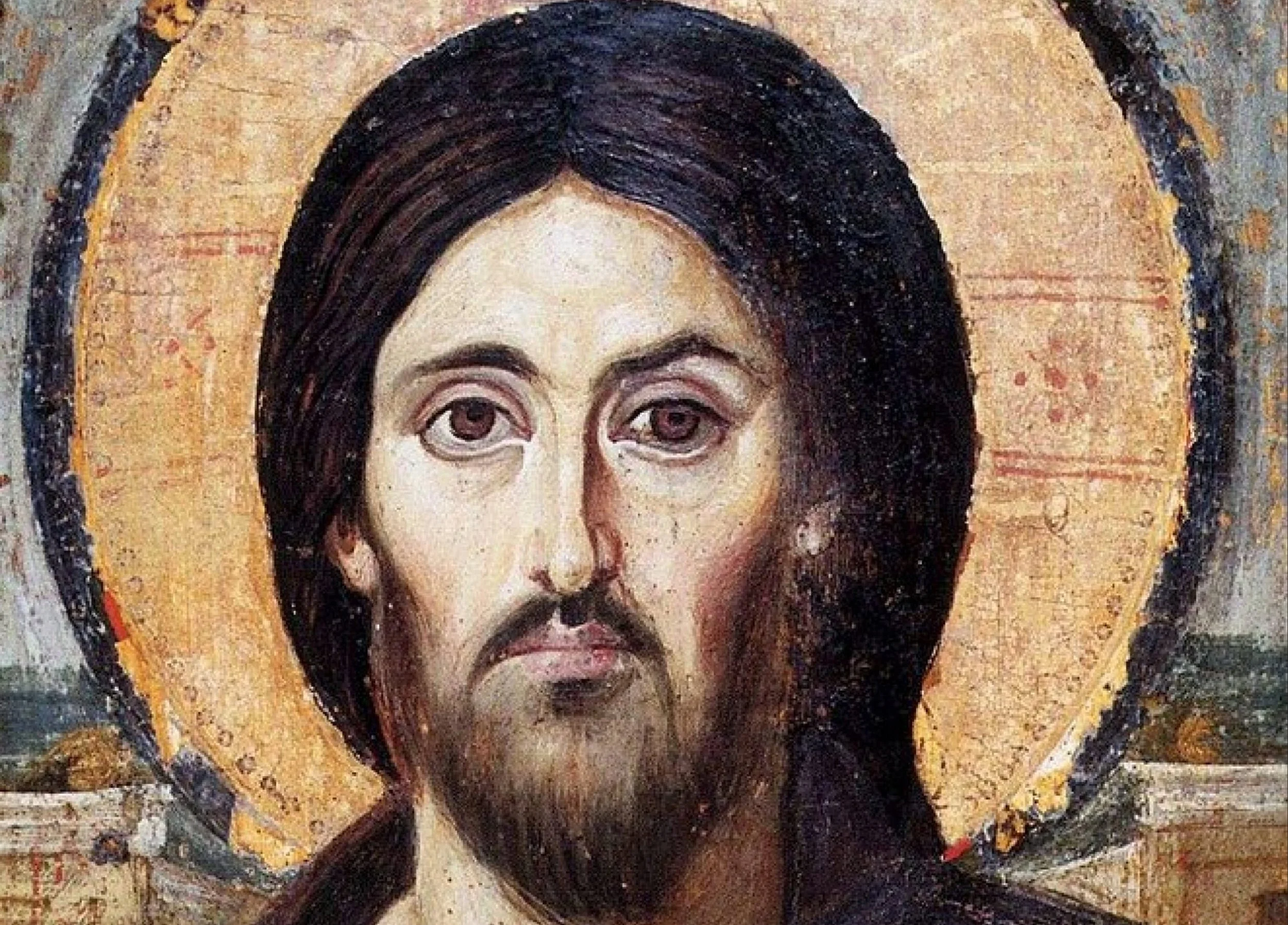 Close-up detail of the Christ Pantocrator icon of Jesus Christ (Yeshua), a Byzantine sacred image emphasizing divine authority, compassion, and the penetrating, asymmetrical gaze central to Eastern Christian iconography.