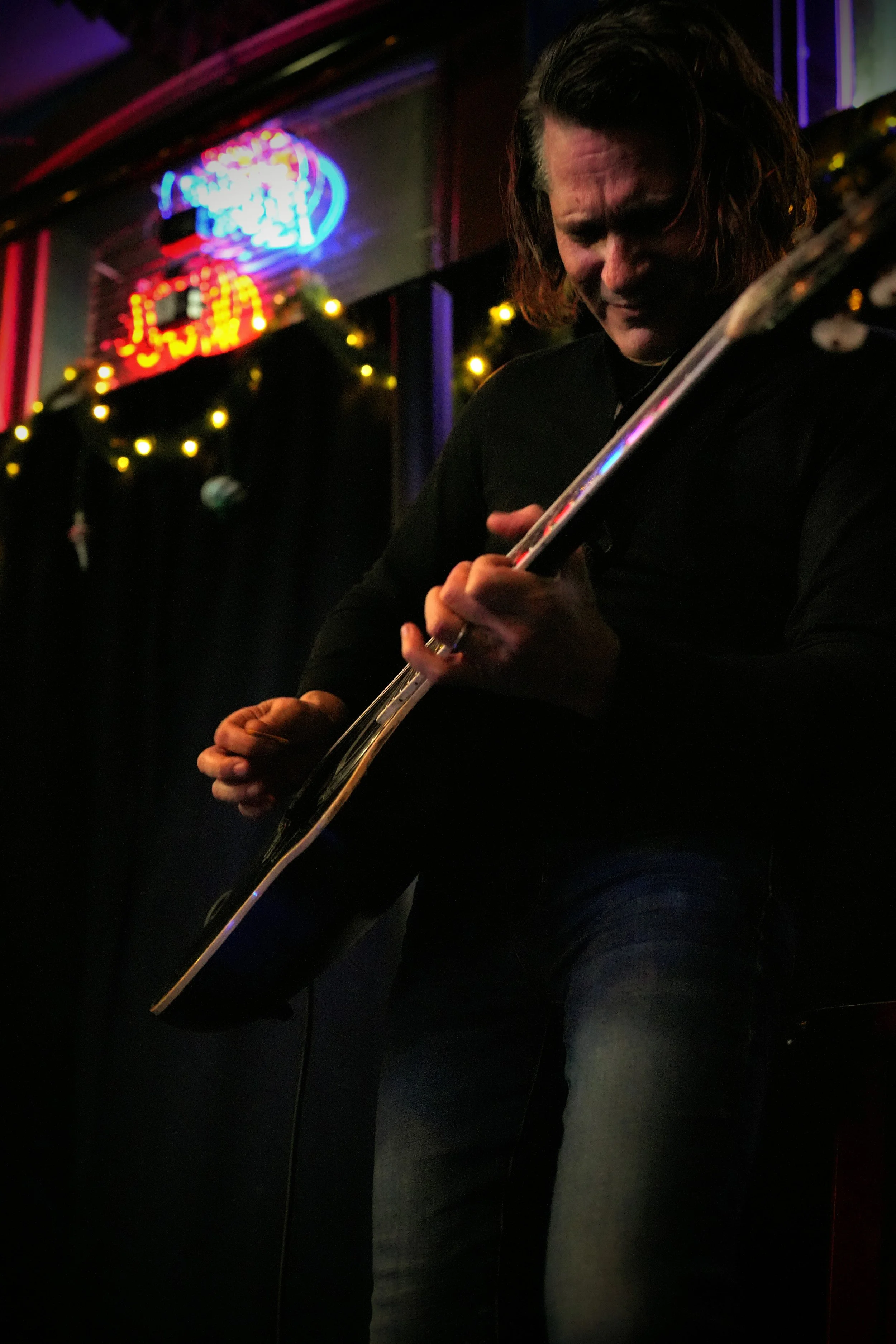 Benito DeBartoli performing acoustic blues under the glowing lights of the world-famous Slippery Noodle in Indianapolis.
