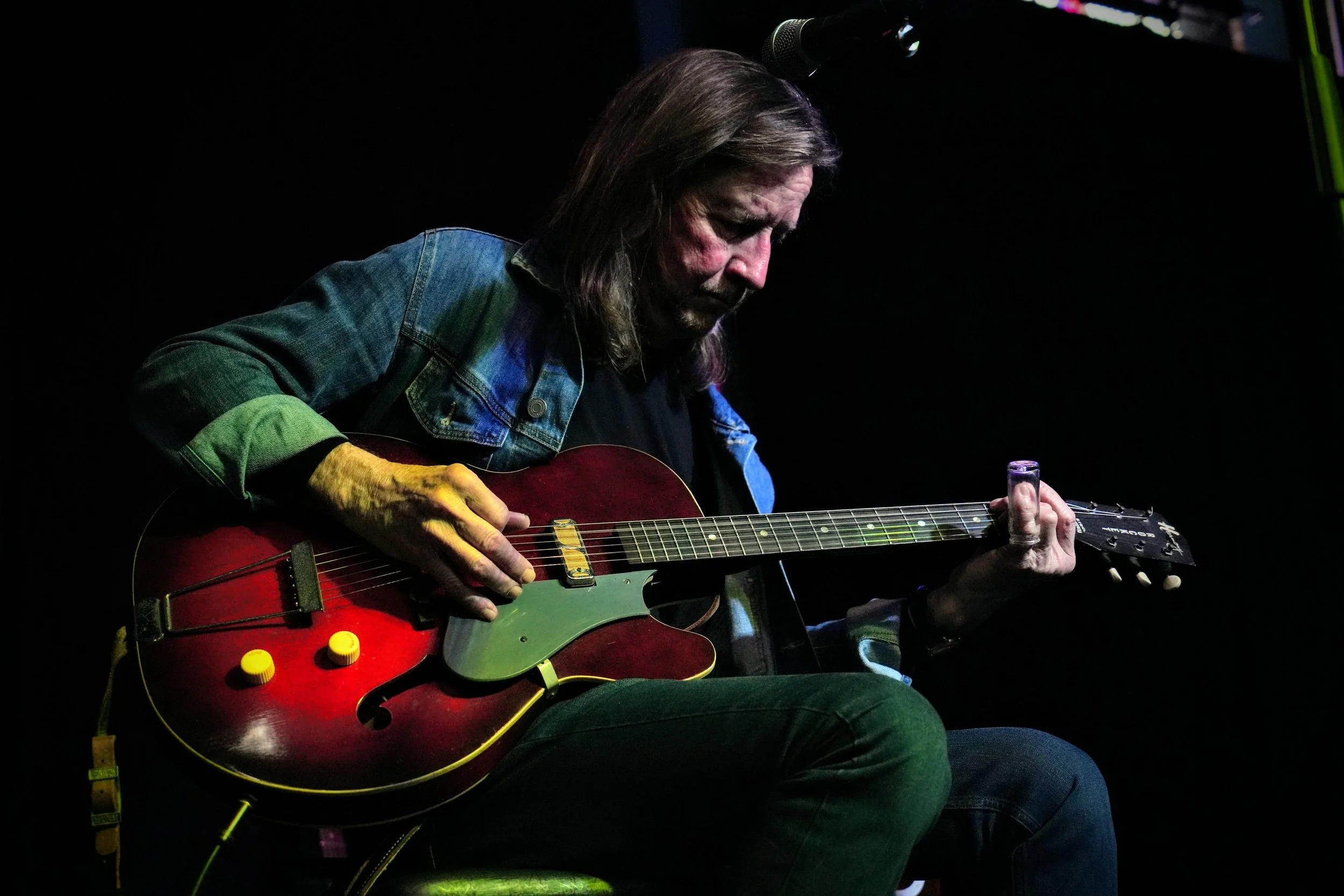 Gordon Bonham Jr., a world-class guitar player, performing on stage under the glowing lights of the world-famous Slippery Noodle in Indianapolis.