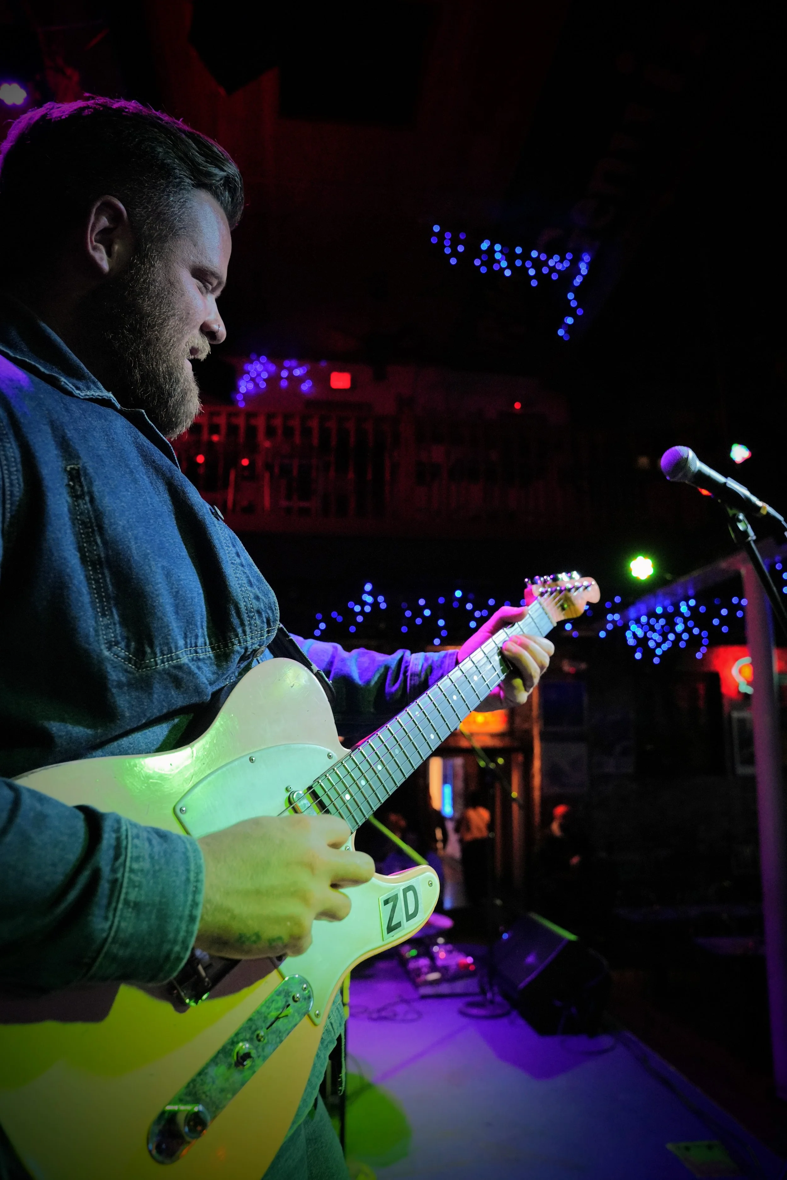 Zach Day performing live on a Fender Telecaster under the glowing lights of the world-famous Slippery Noodle in Indianapolis.