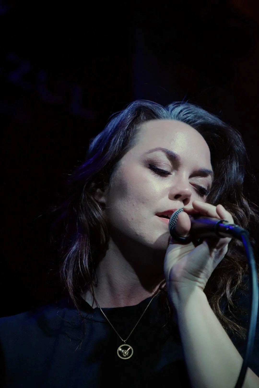 Natalie Marque performing soulfully as the band leader of GrooveSmash under the glowing lights of the world-famous Slippery Noodle in Indianapolis.