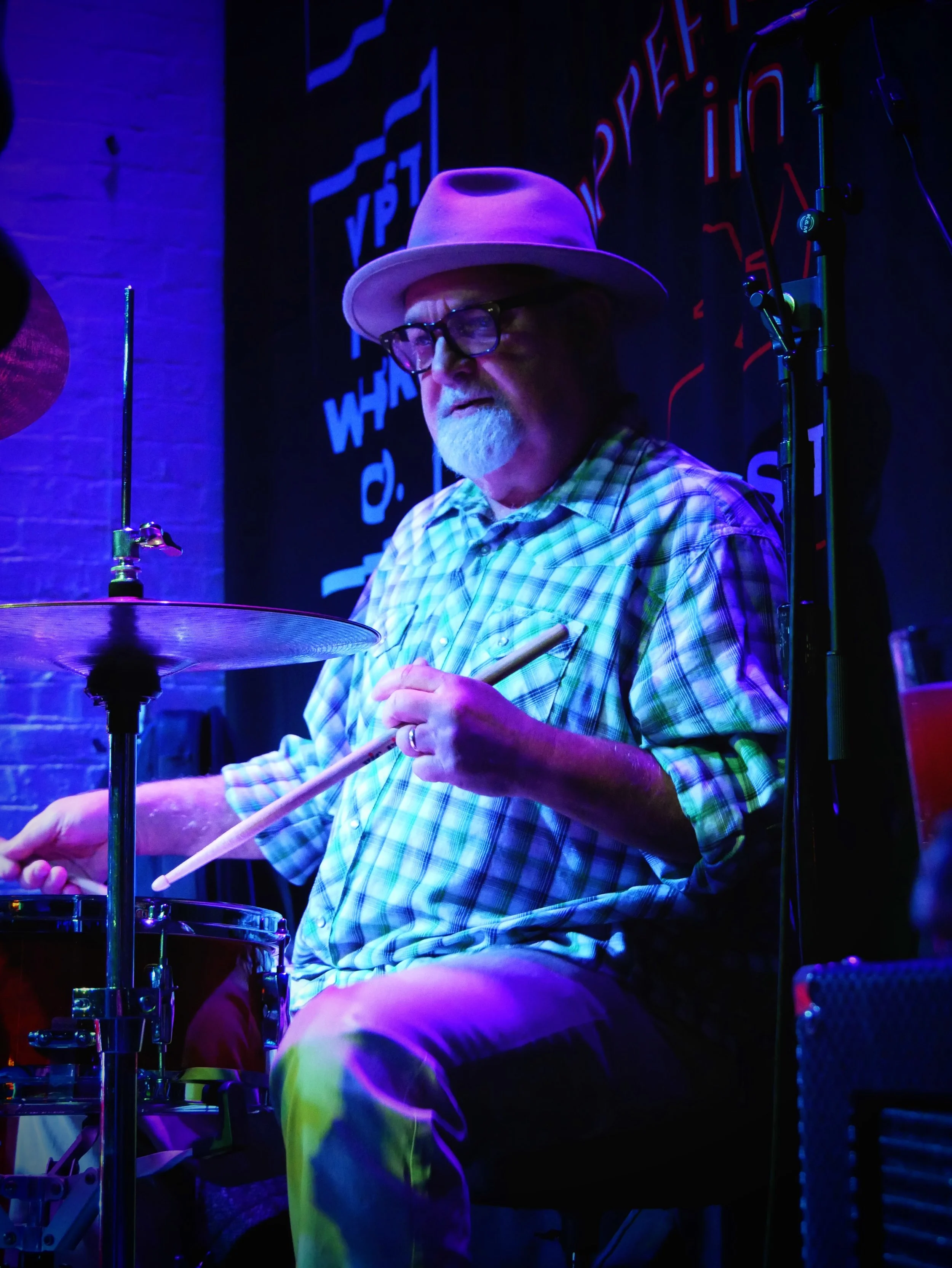 CJ Pile performing live on the drums under the glowing lights of the world-famous Slippery Noodle in Indianapolis.