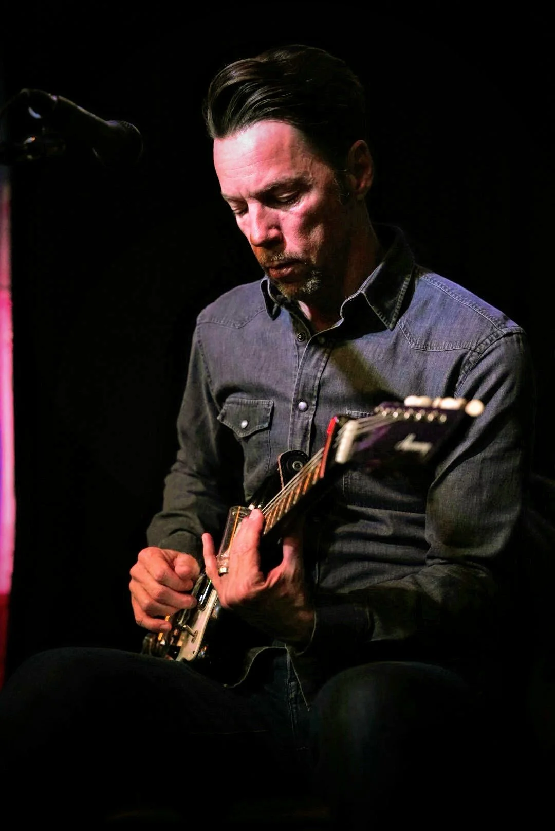 Paul Holdman performing live slide blues guitar under the glowing lights of the world-famous Slippery Noodle in Indianapolis