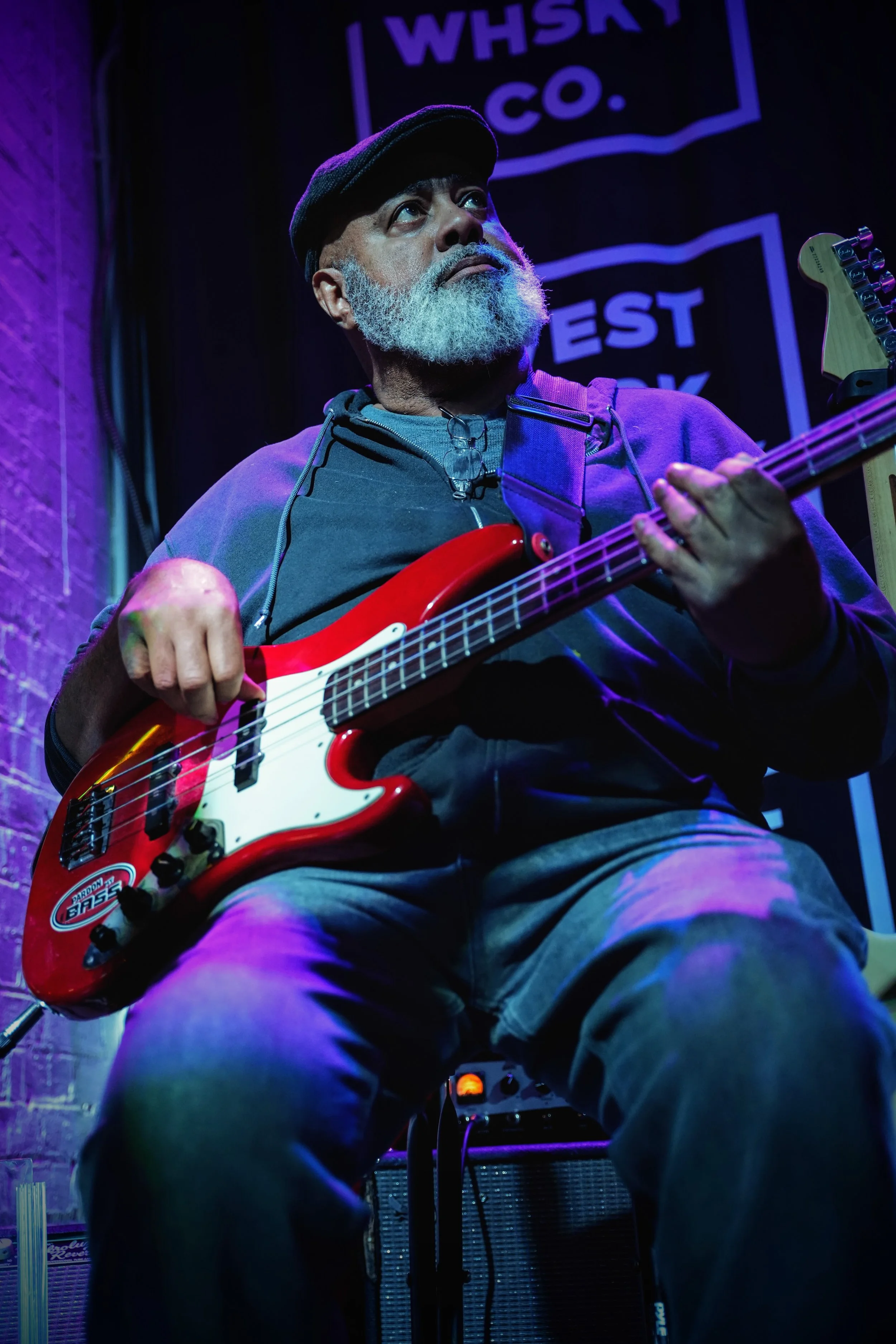 Jerome Mills playing Bass guitar under the glowing lights of the world-famous Slippery Noodle in Indianapolis.