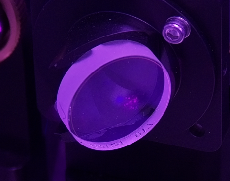 Dust particles on a lens surface, resolved by the zoom lens.