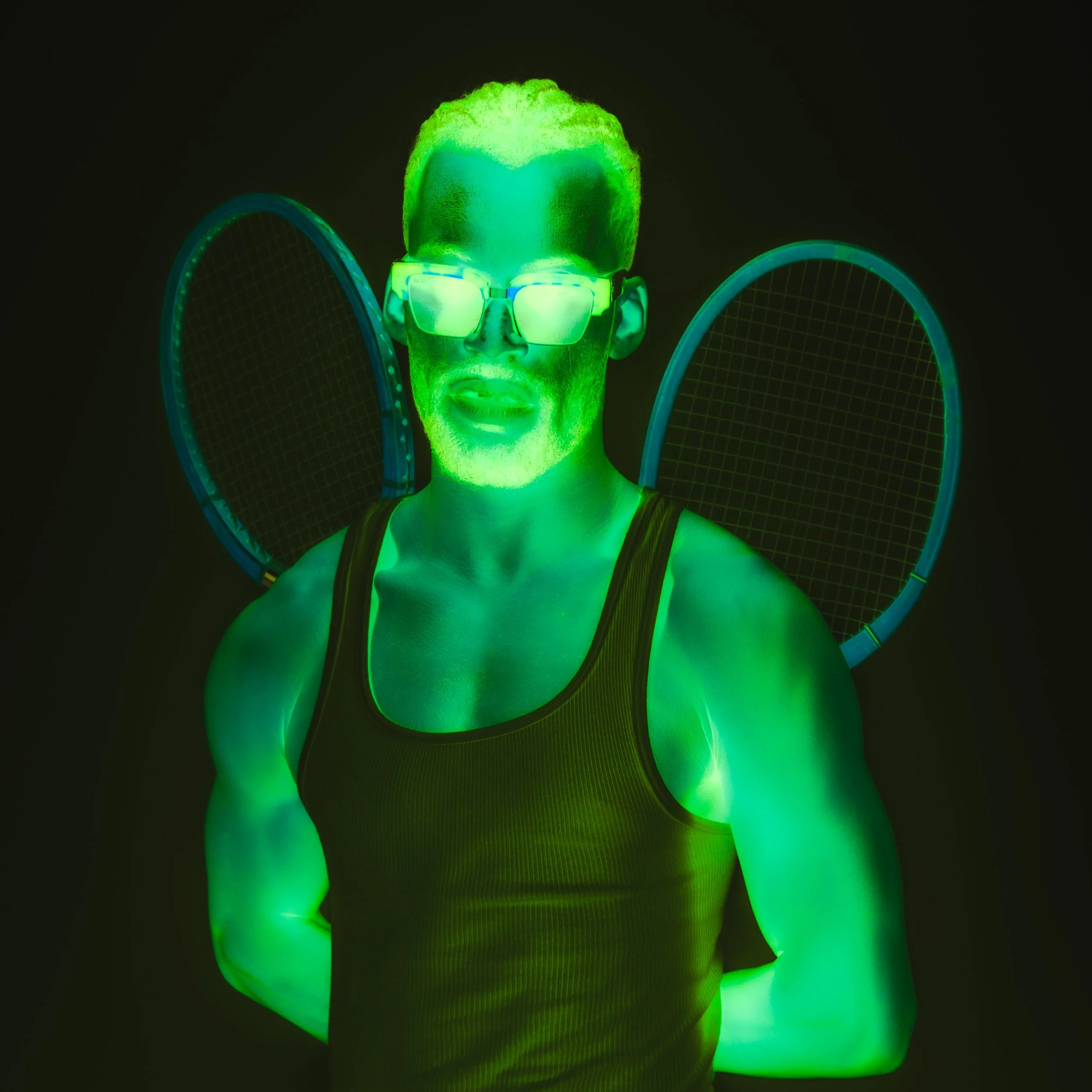 Person with glowing green skin, wearing glasses, against a black background, with tennis rackets on their back, wearing a tank top.