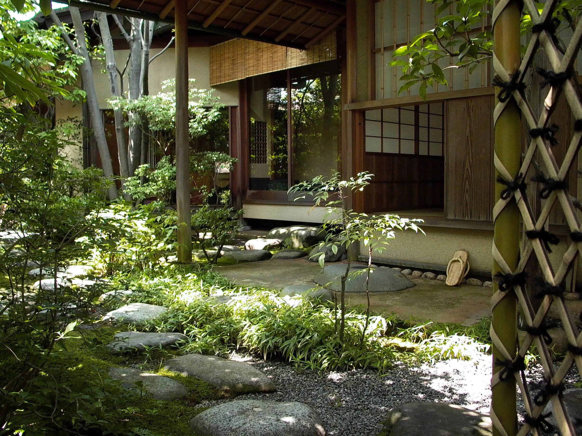 悟道庵点景 | 伝統的な日本家屋の縁側と庭園の風景、緑豊かな植物と石が配置されている