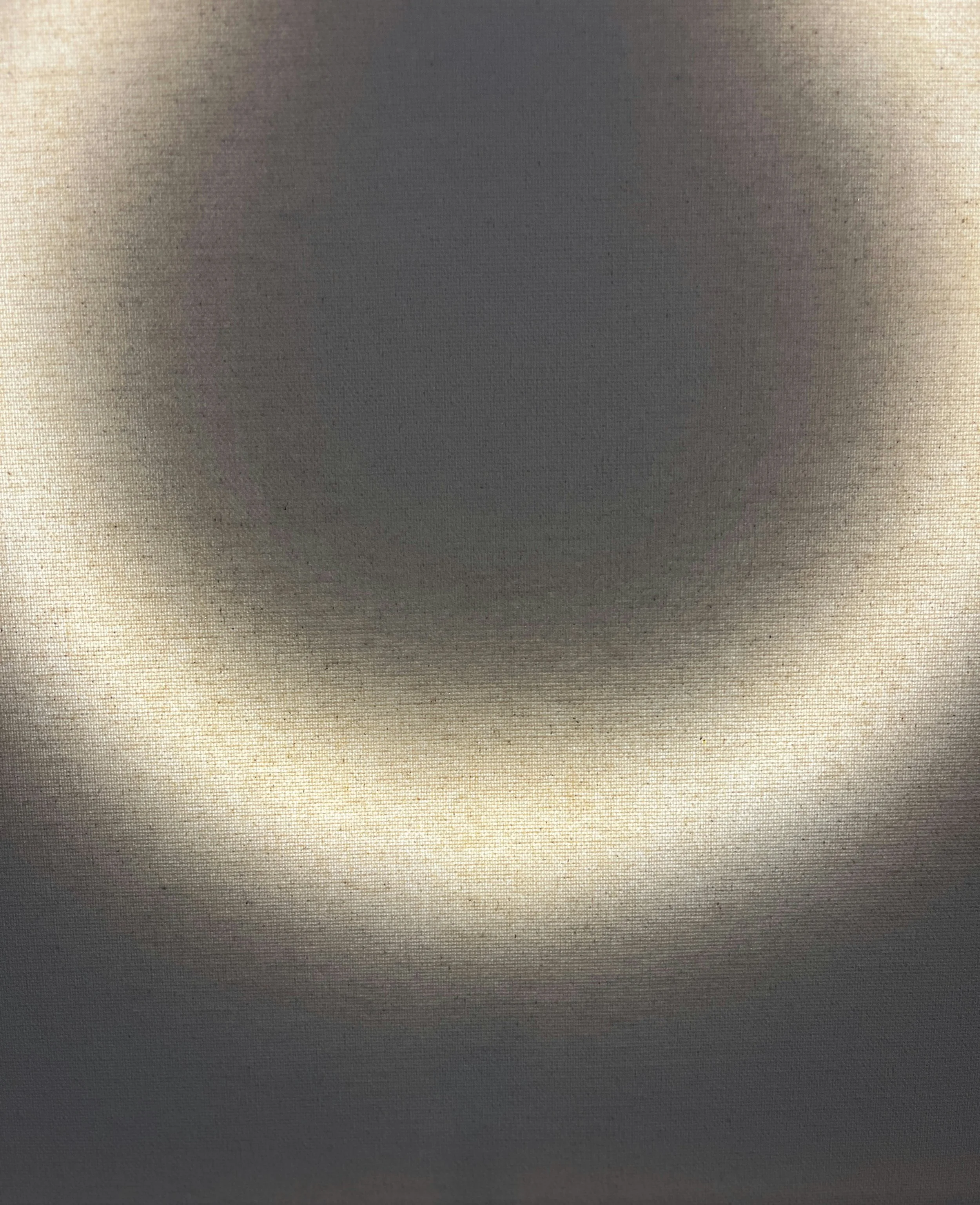 Close-up of a ceiling light with a circular glow and a dark center.