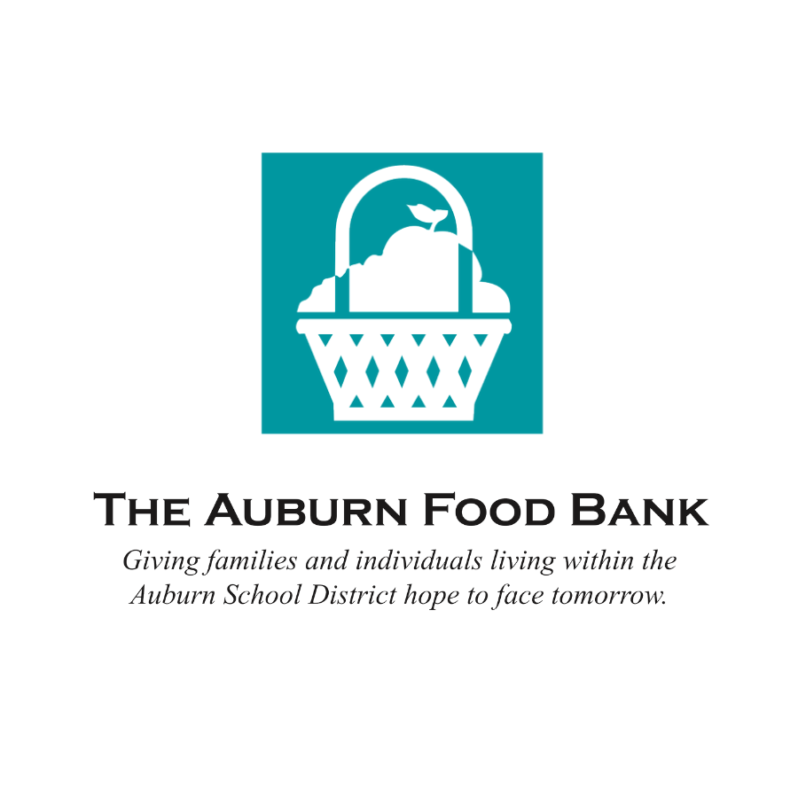 Logo of The Auburn Food Bank with a graphic of a basket filled with food and a small bird, and text indicating it serves families and individuals in the Auburn School District.