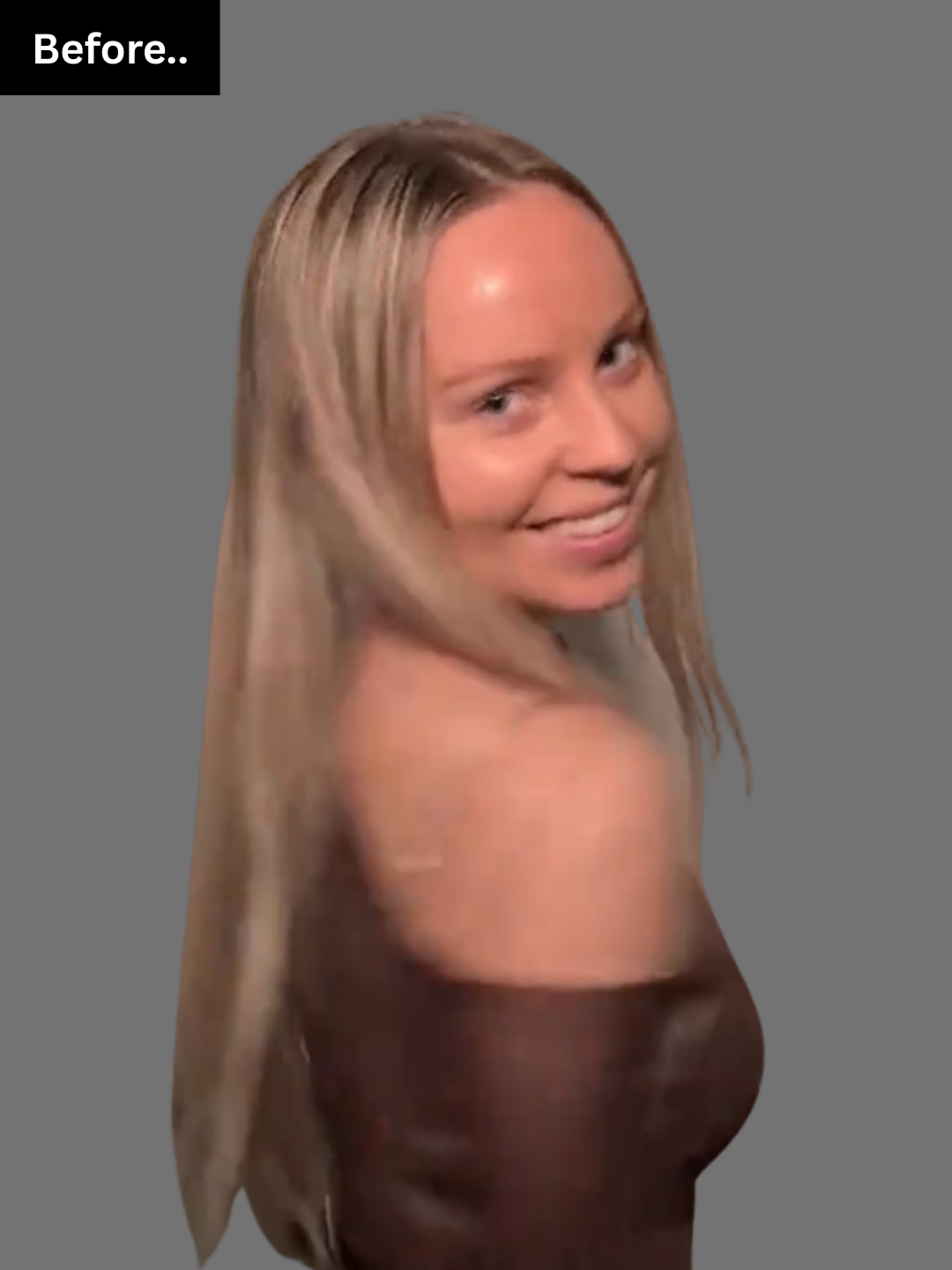 A woman with long blonde hair smiling and looking over her shoulder against a gray background.