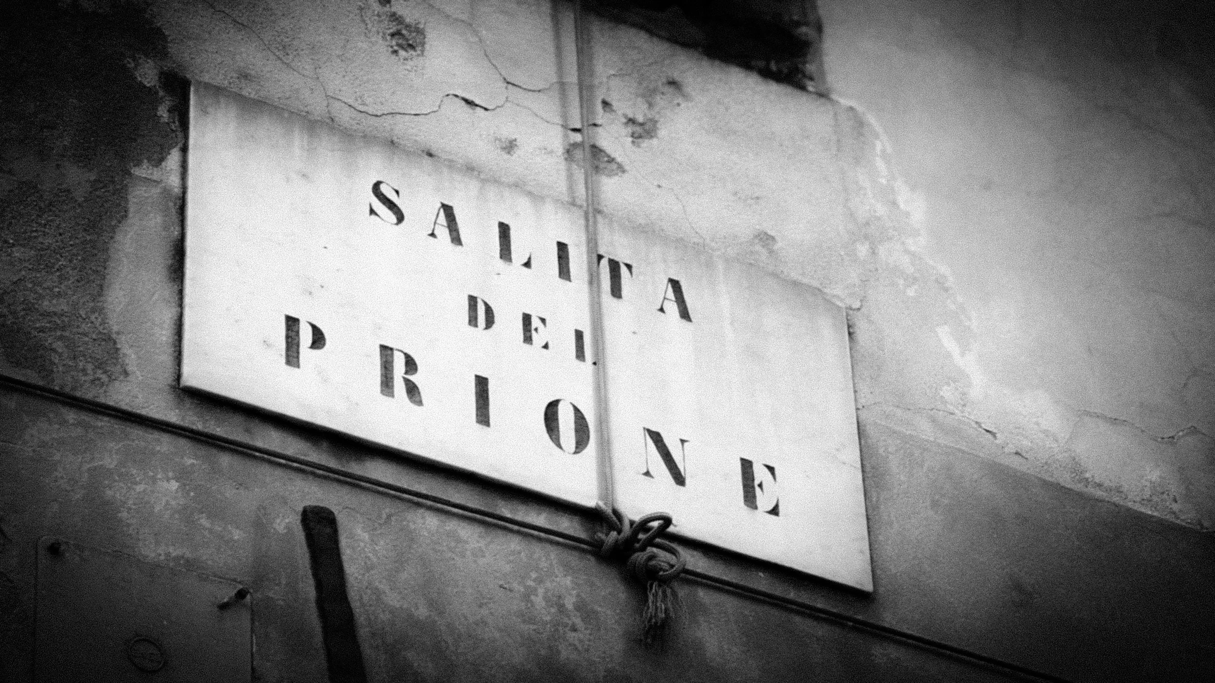 Segnale in stile vintage con scritta 'Sanità delle Provinz'. La parete dietro è rovinata e ha crepe.